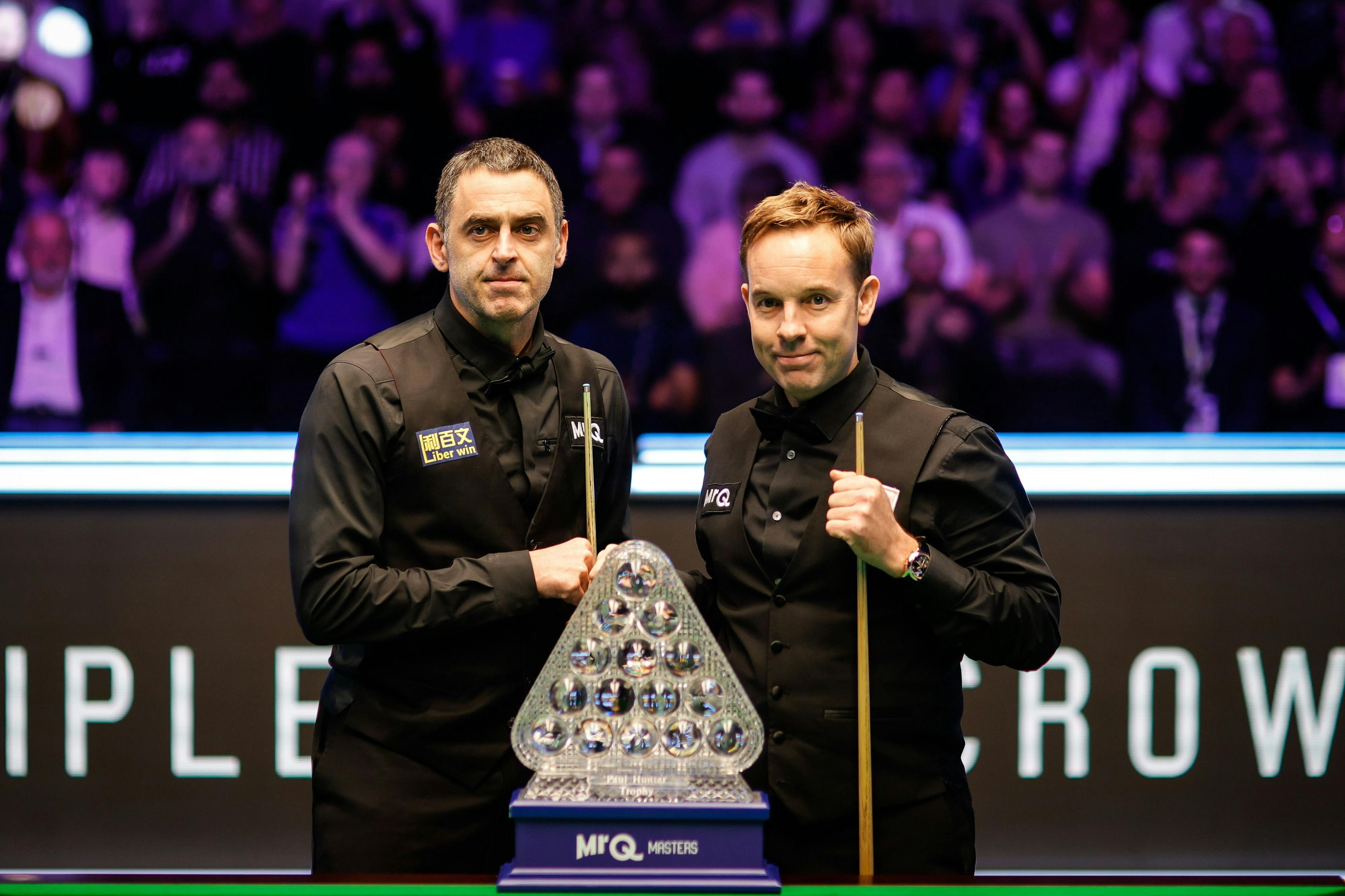 Two snooker players with trophy