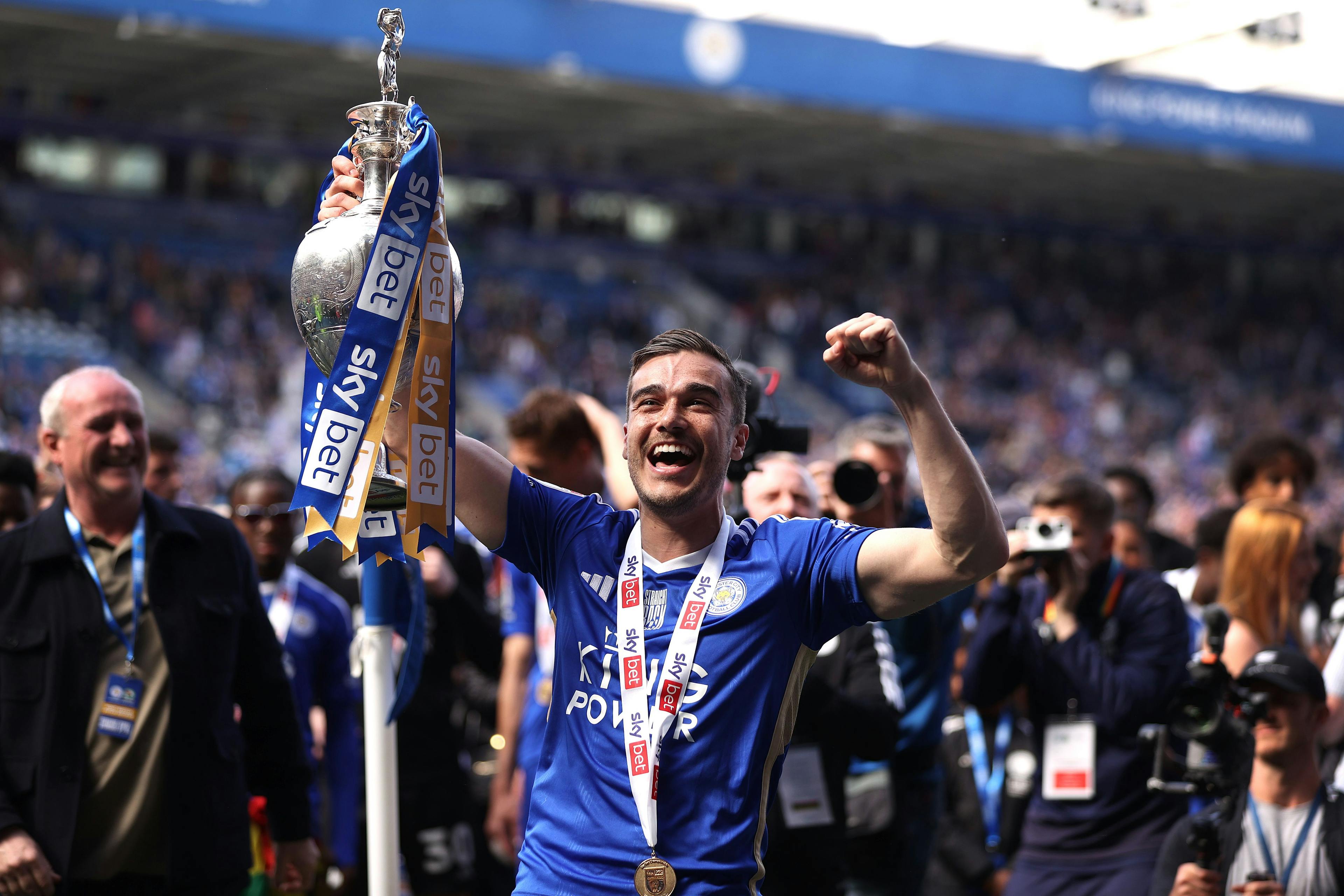 Harry Winks of Leicester City celebrates with the trophy following promotion during the Sky Bet Championship
