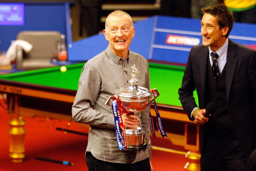 Steve Davis holding a trophy following his retirement from professional snooker 