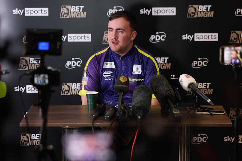Darts player addressing a press conference 