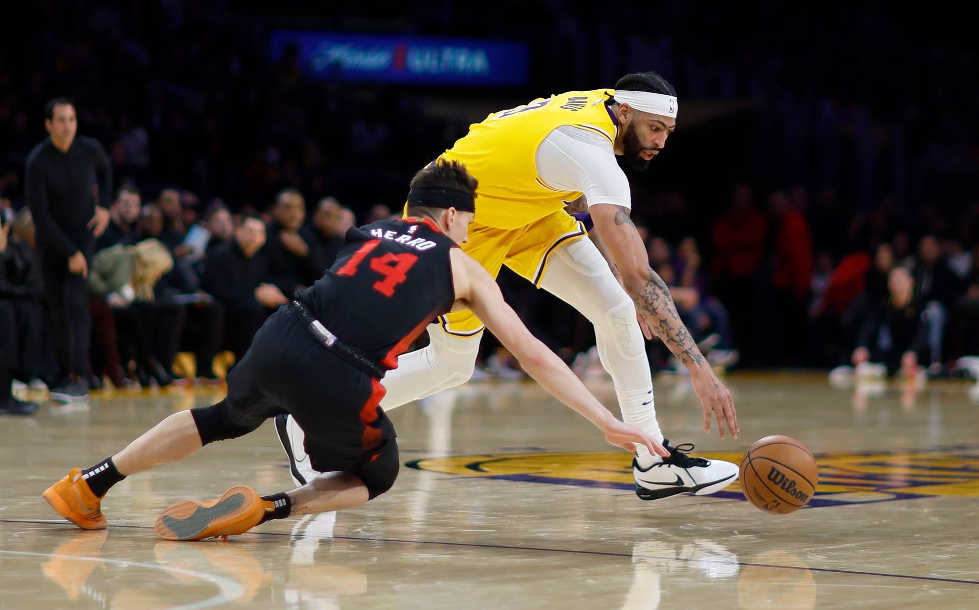 Anthony Davis, battles Miami Heat guard Tyler Herro