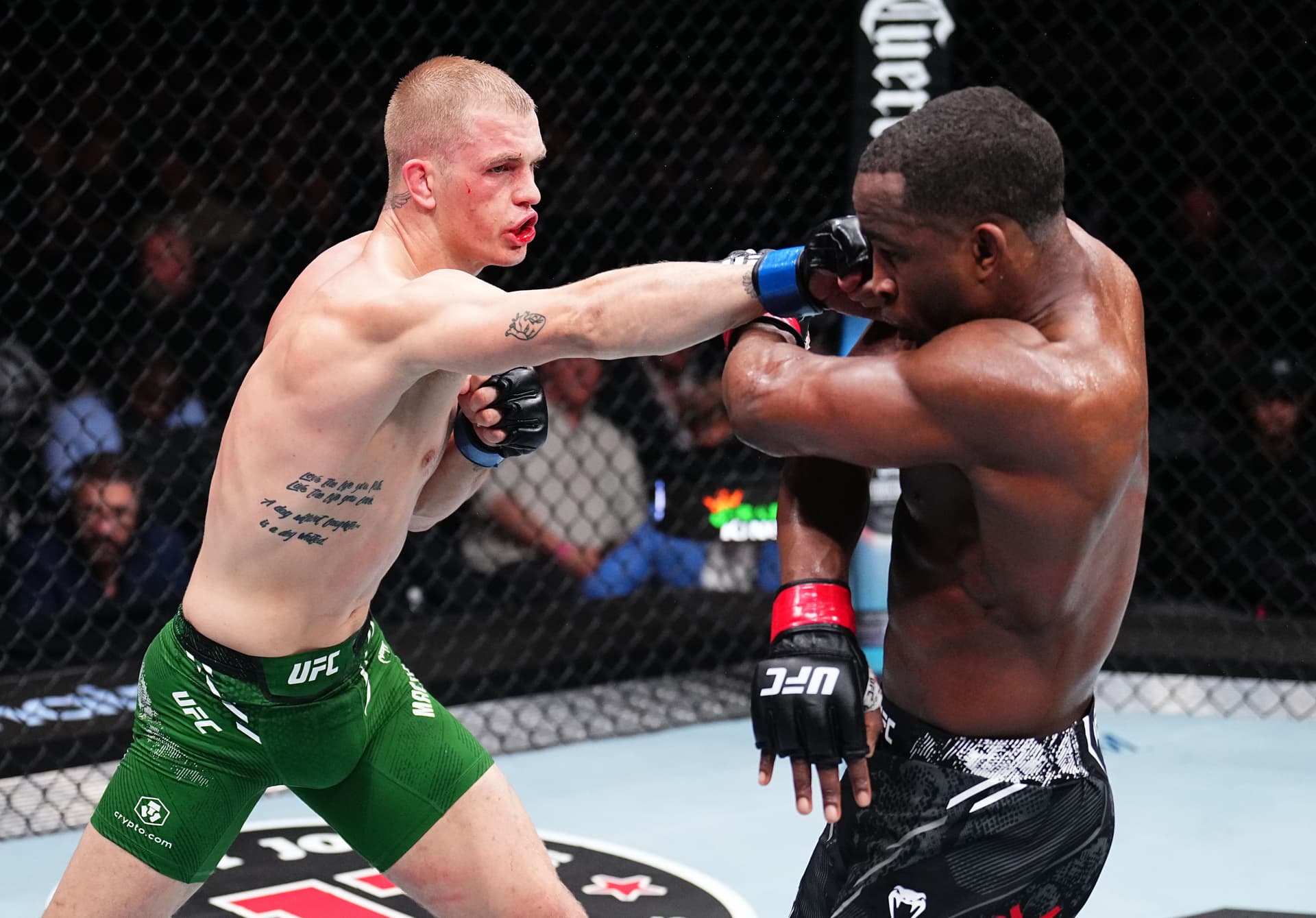 Ian Garry of Ireland punches Geoff Neal