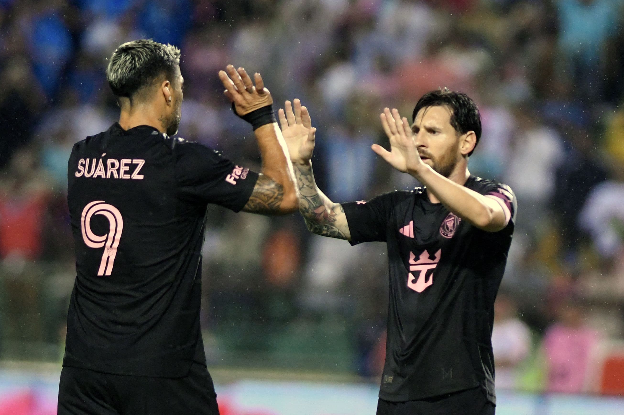 Lionel Messi (L) celebrates with teammate Uruguayan