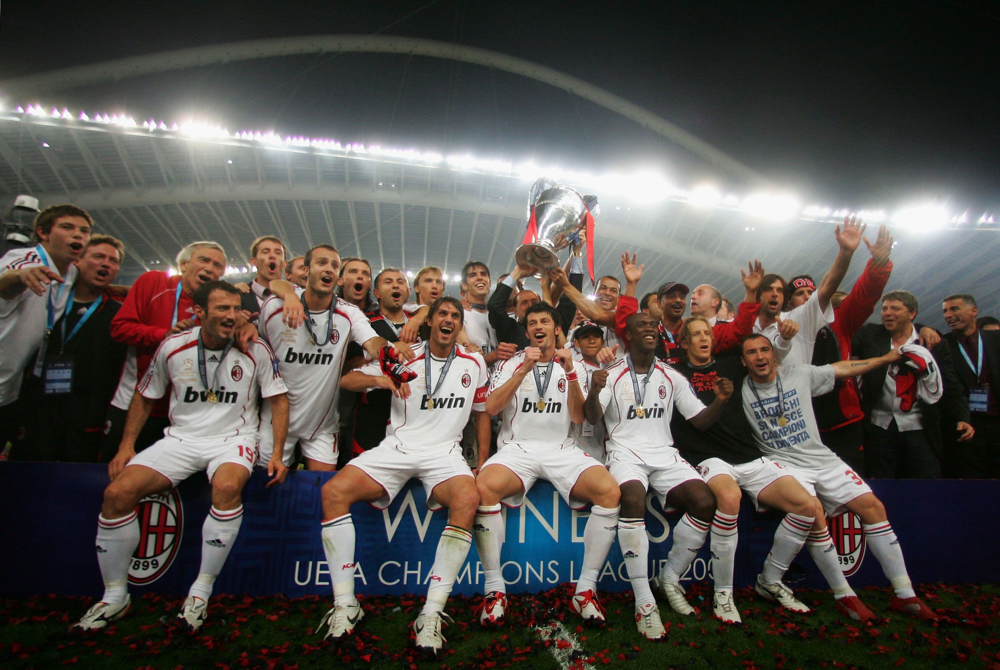 Milan players celebrate with the trophy