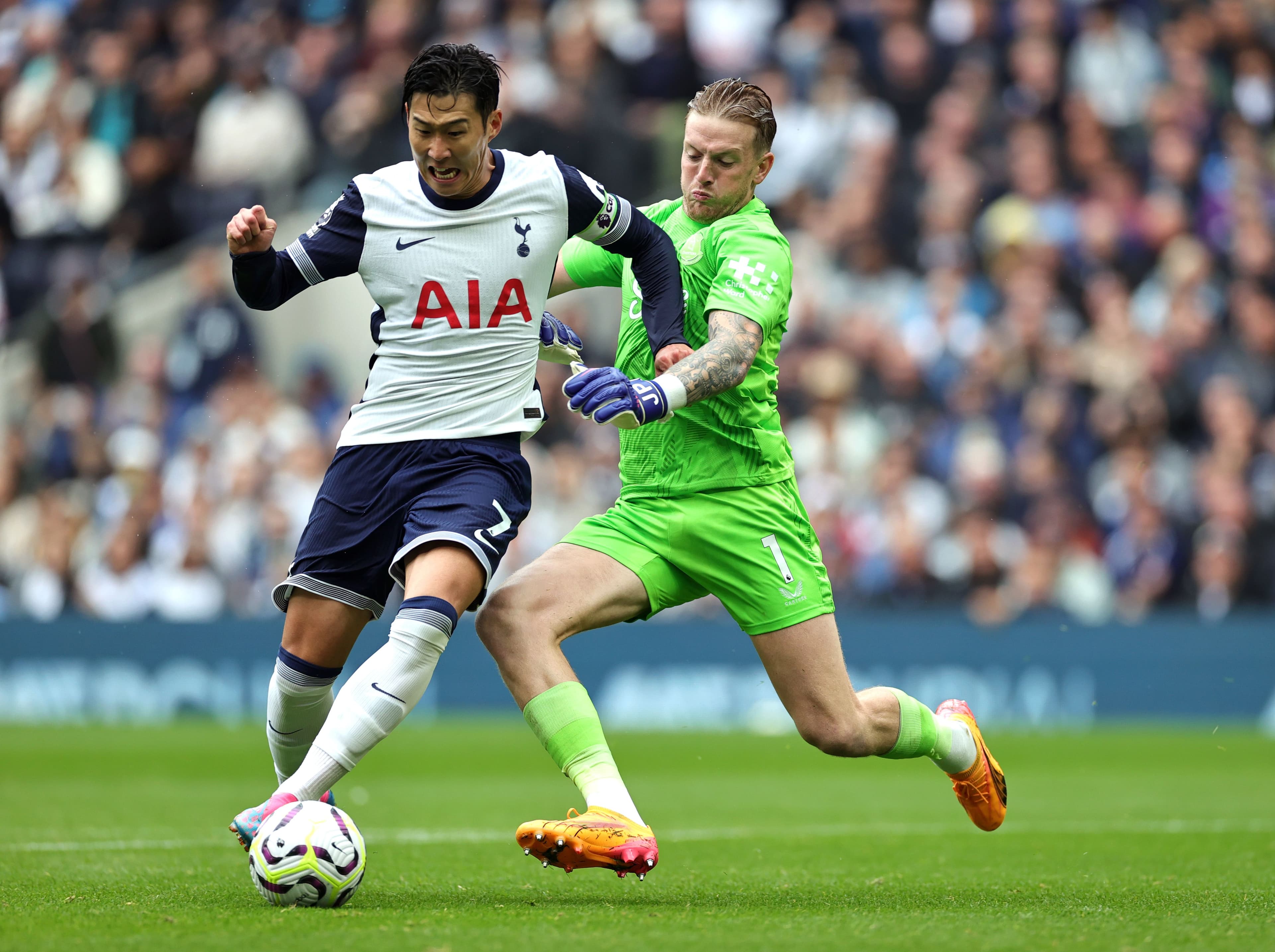 Son Heung-Min takes the ball around Jordan Pickford