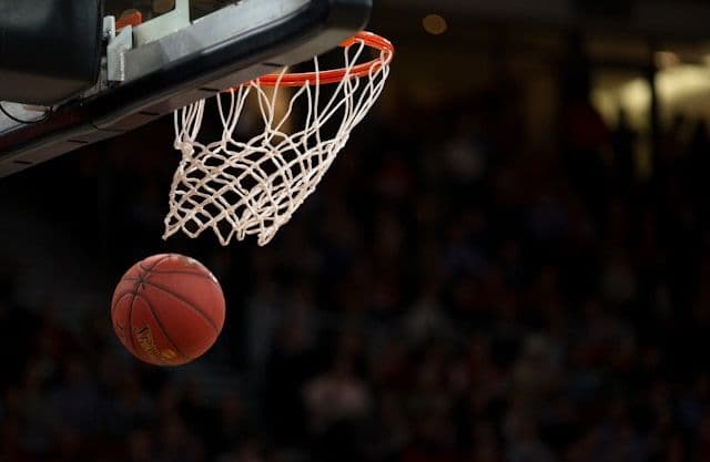 A basketball going through a hoop