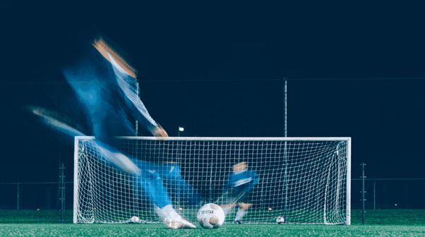 timelapse photo of footballer kicking bal