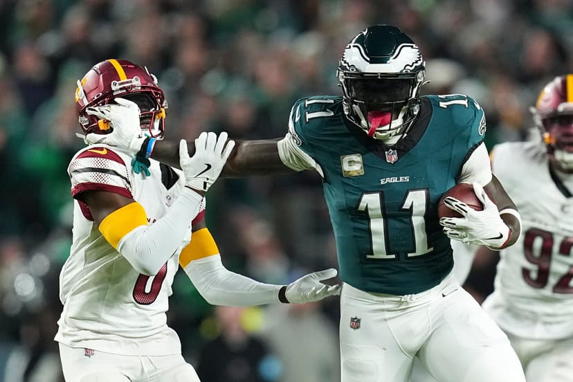 A.J. Brown runs with the ball against Mike Sainristil