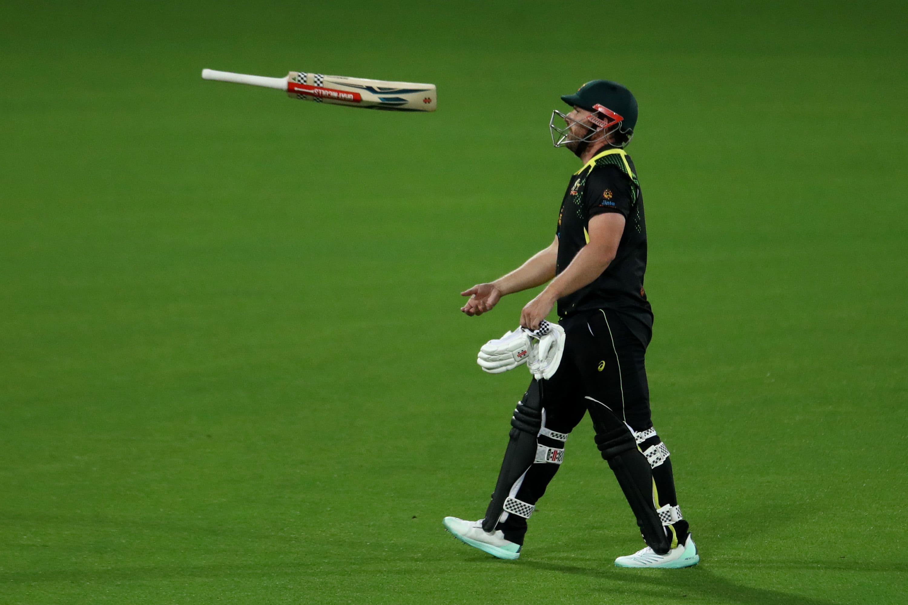 Aaron Finch of Australia walks off the field after been dismissed by David Willey.jpg