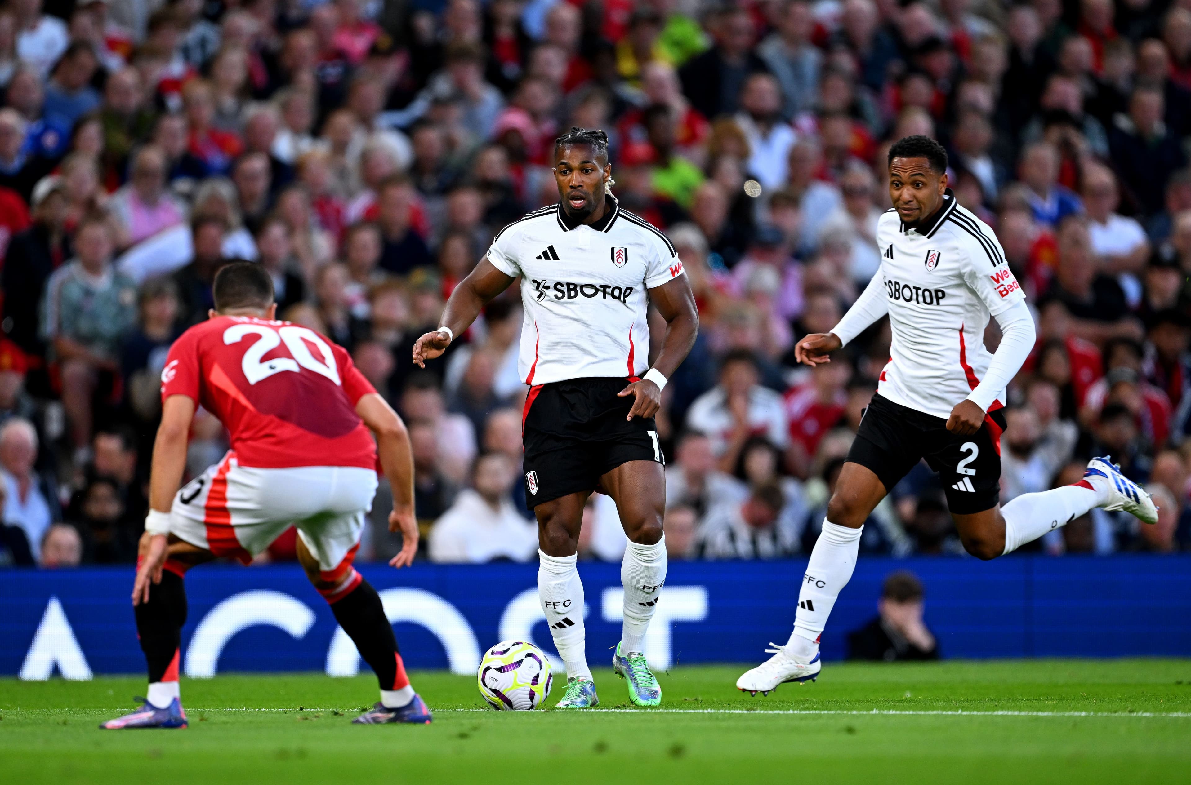 Adama Traore controls the ball whilst under pressure from Diogo Dalot.jpg