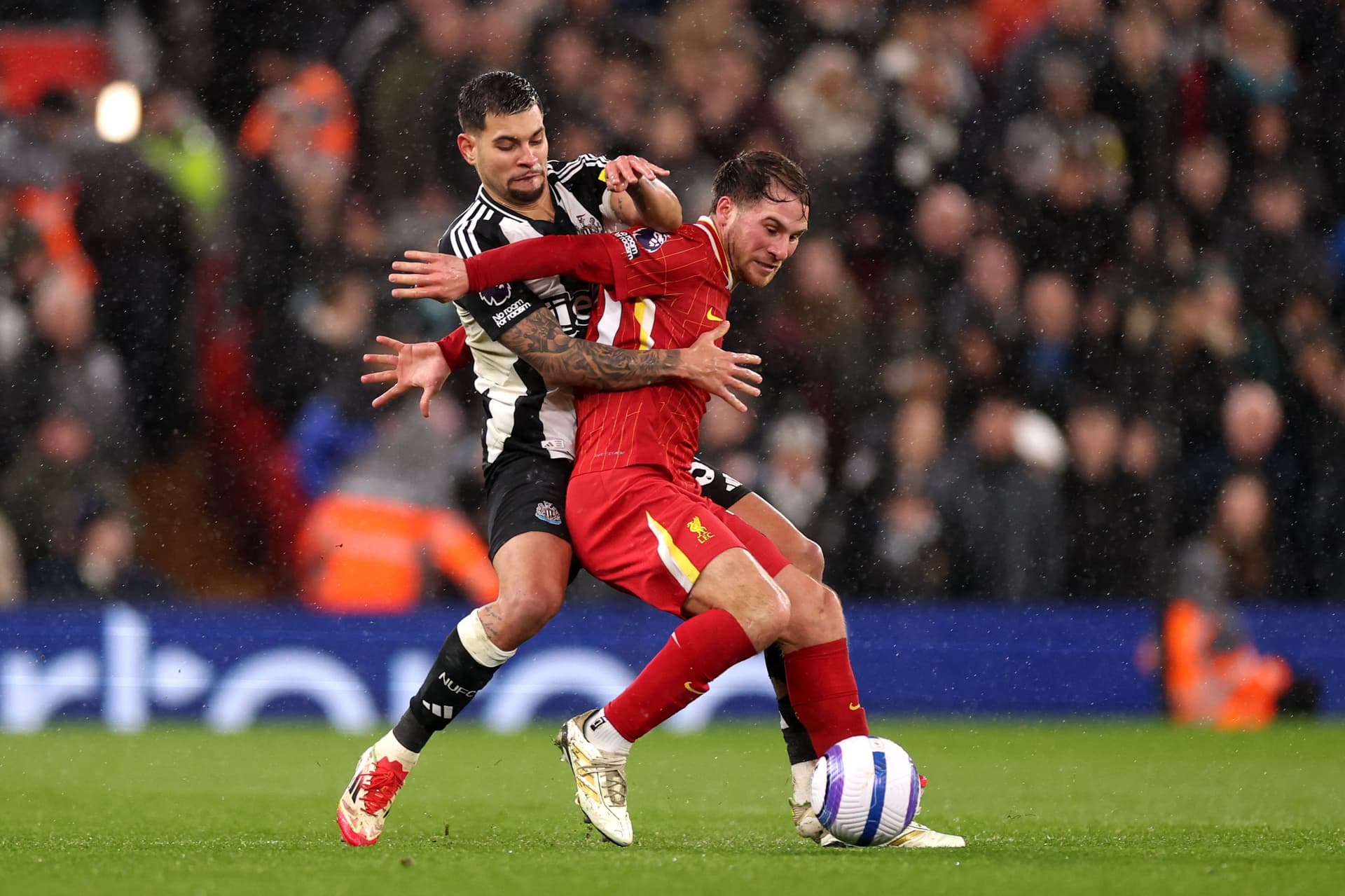Alexis Mac Allister of Liverpool is challenged by Bruno Guimaraes of Newcastle United