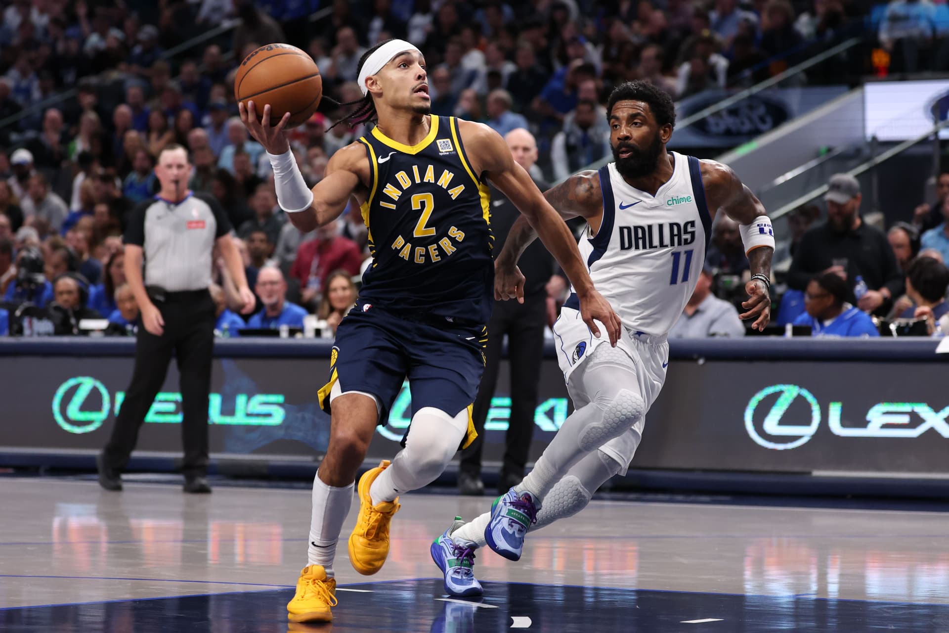 Andrew Nembhard drives past Kyrie Irving