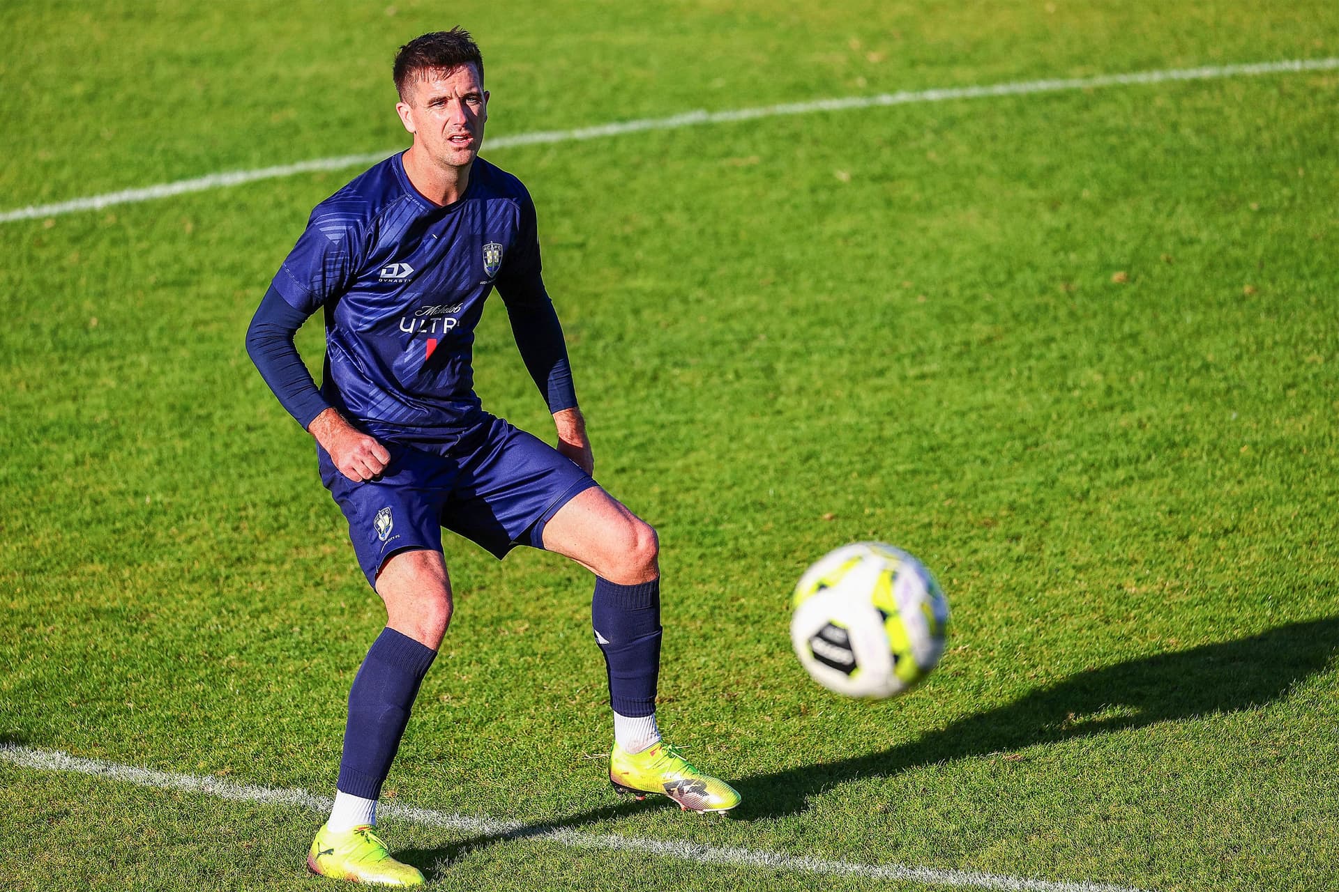 Angus Kilkolly controlling the ball during the football match