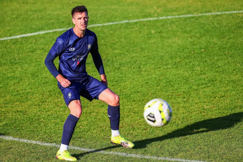 Angus Kilkolly controlling the ball during the football match