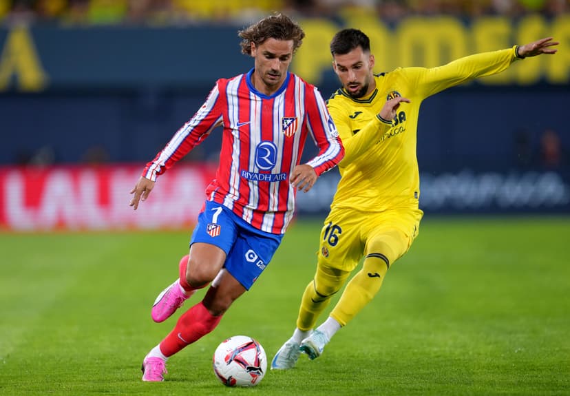 Antoine Griezmann controls the ball under pressure from Alex Baena
