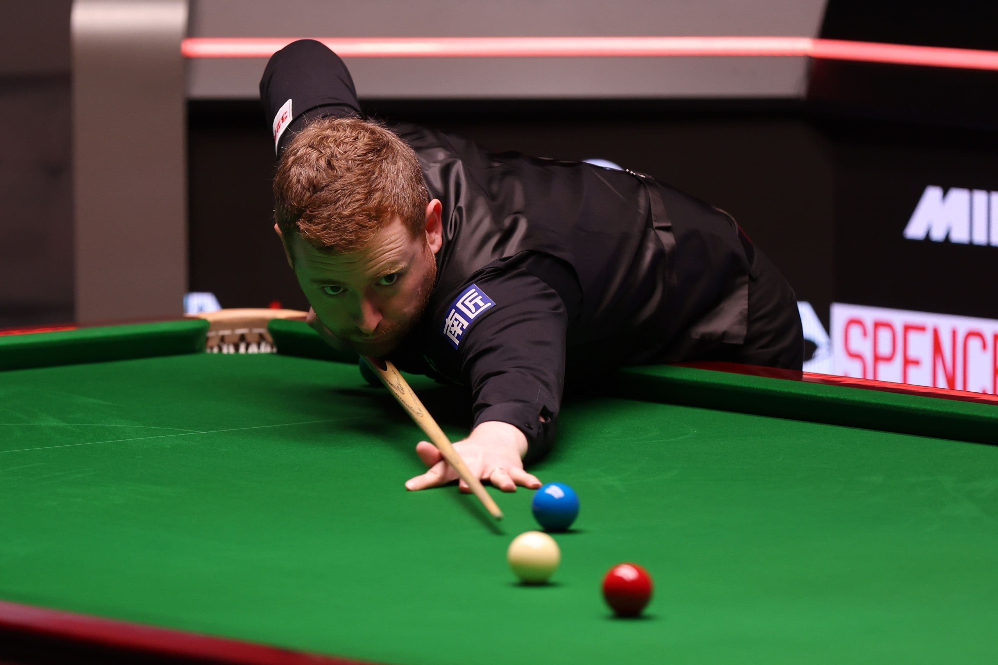 Ben Woollaston of England plays a shot against Si Jiahui of China