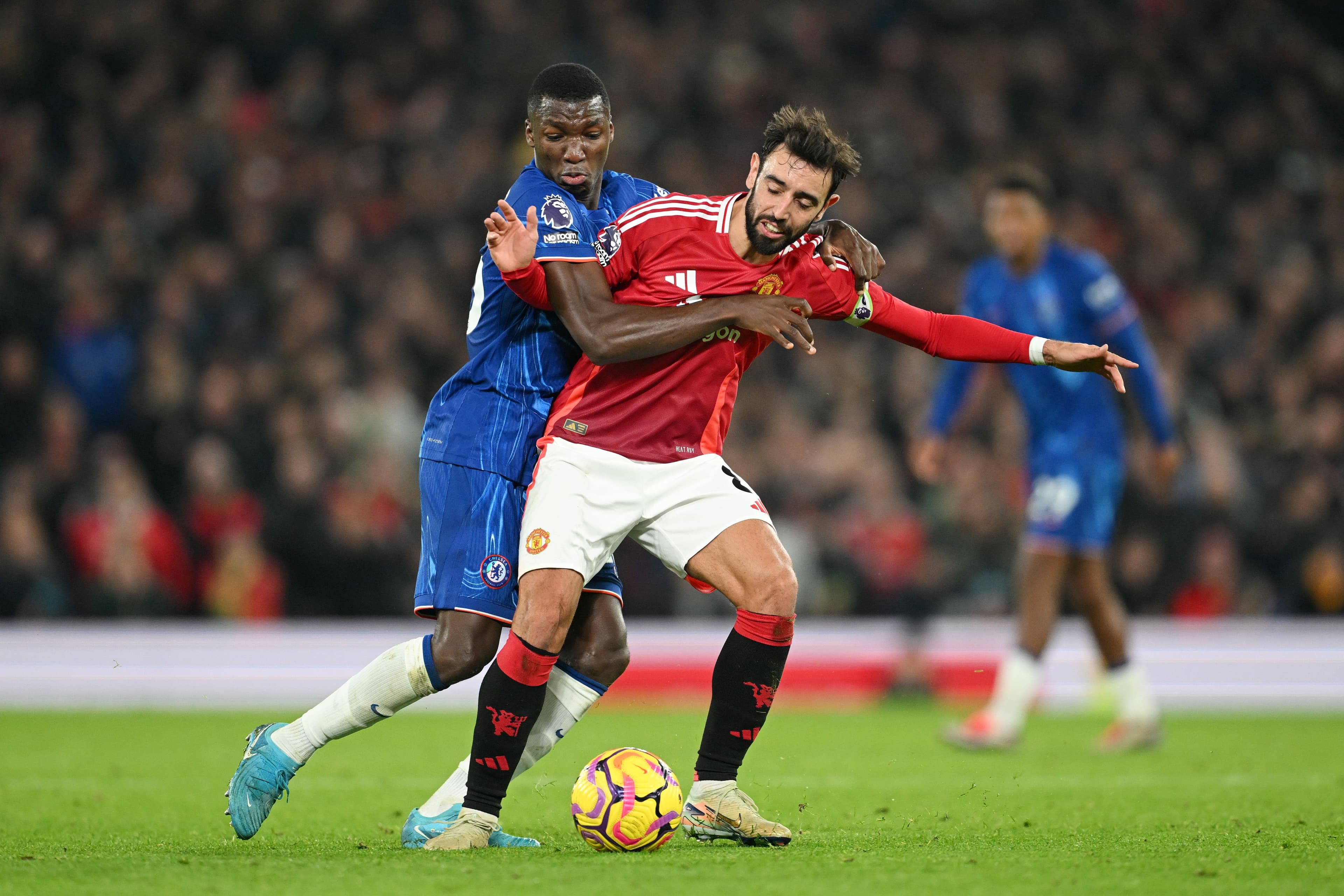 Bruno Fernandes of Manchester United is challenged by Moises Caicedo of Chelsea
