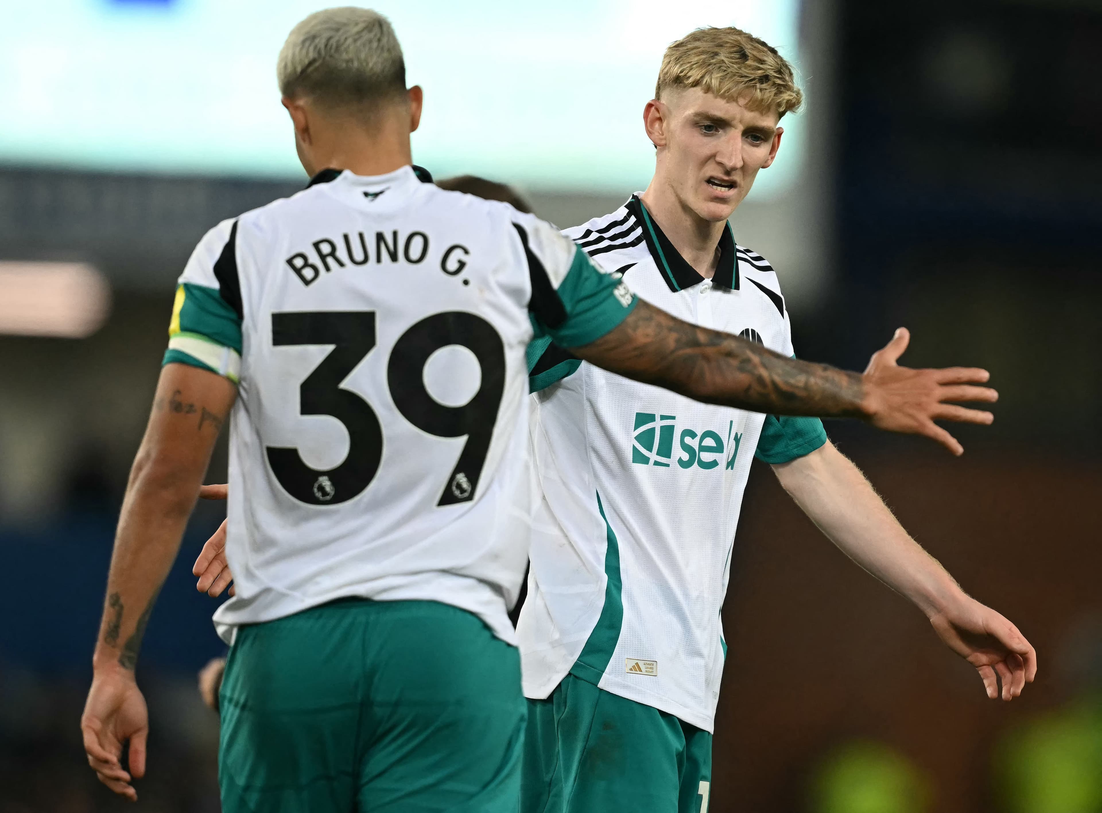 Bruno Guimaraes (L)and Anthony Gordon react after a missed opportunity.jpg