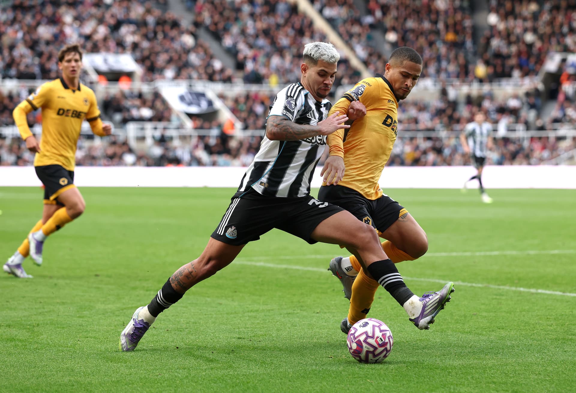 Bruno Guimaraes of Newcastle United is challenged by Joao Gomes