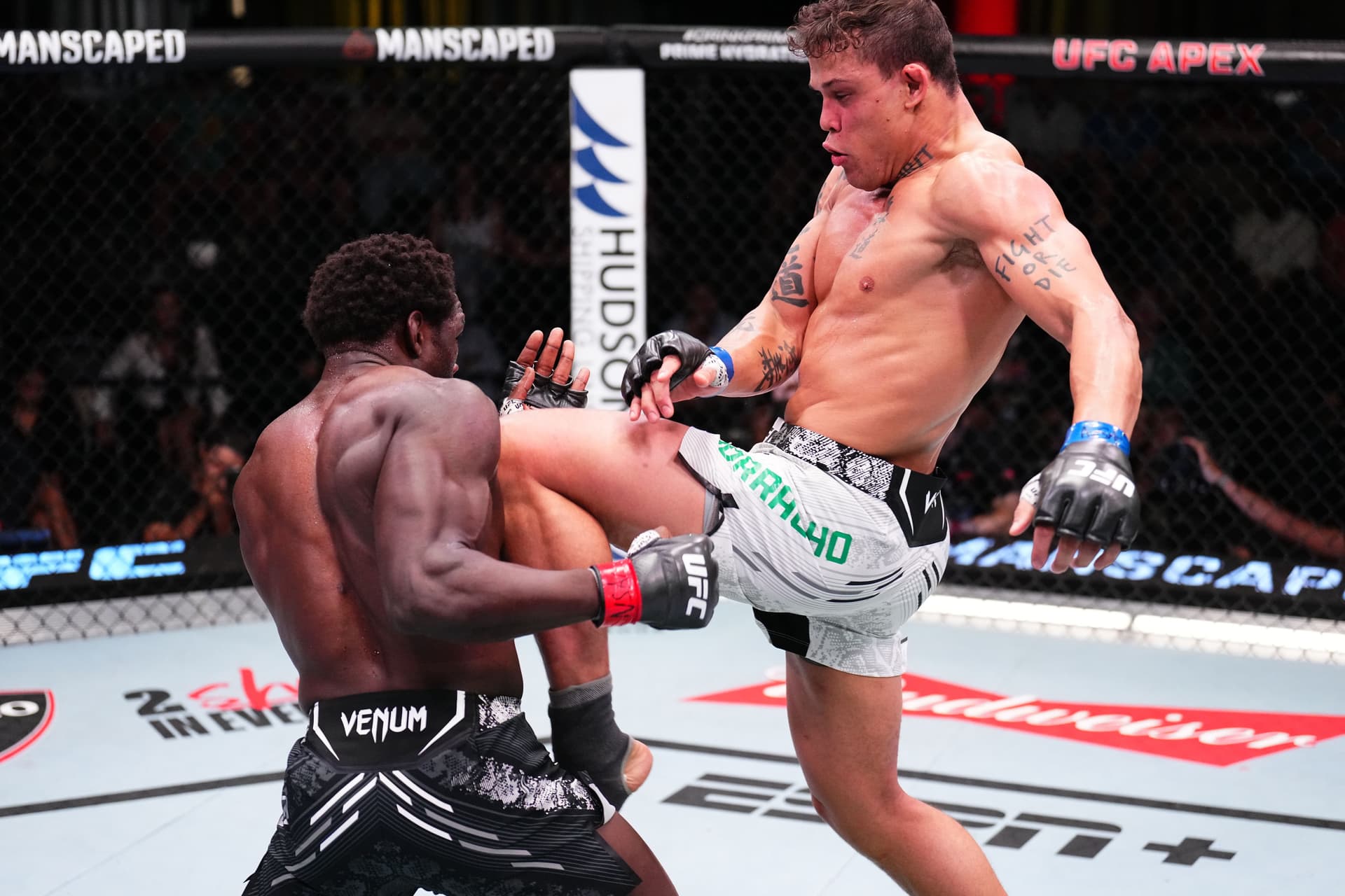 Caio Borralho of Brazil knees Jared Cannonier in a middleweight