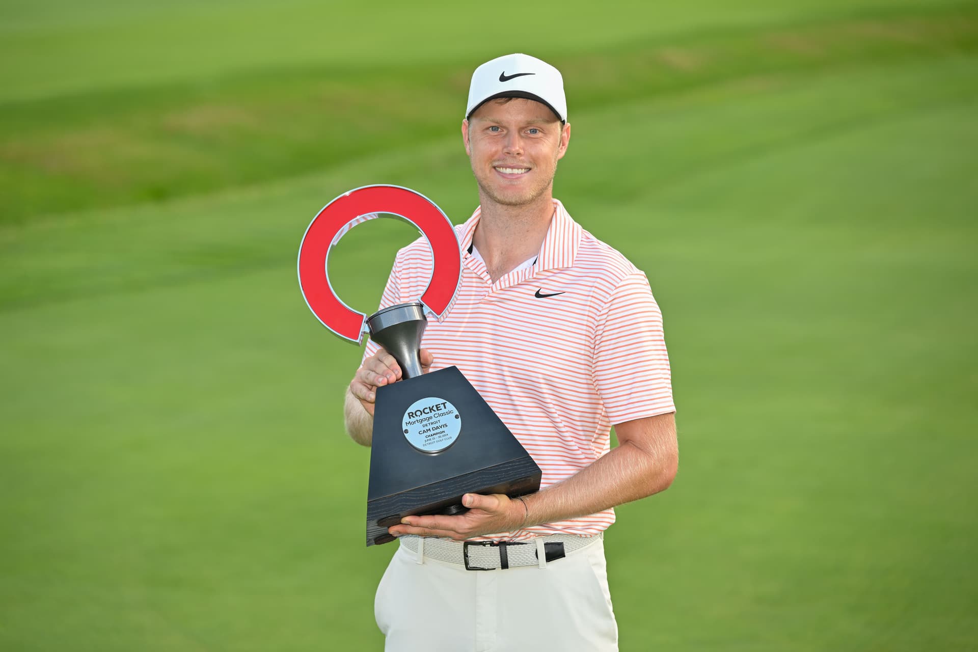Cam Davis of Australia holds the trophy after the final round of the Rocket Mortgage Classic.jpg