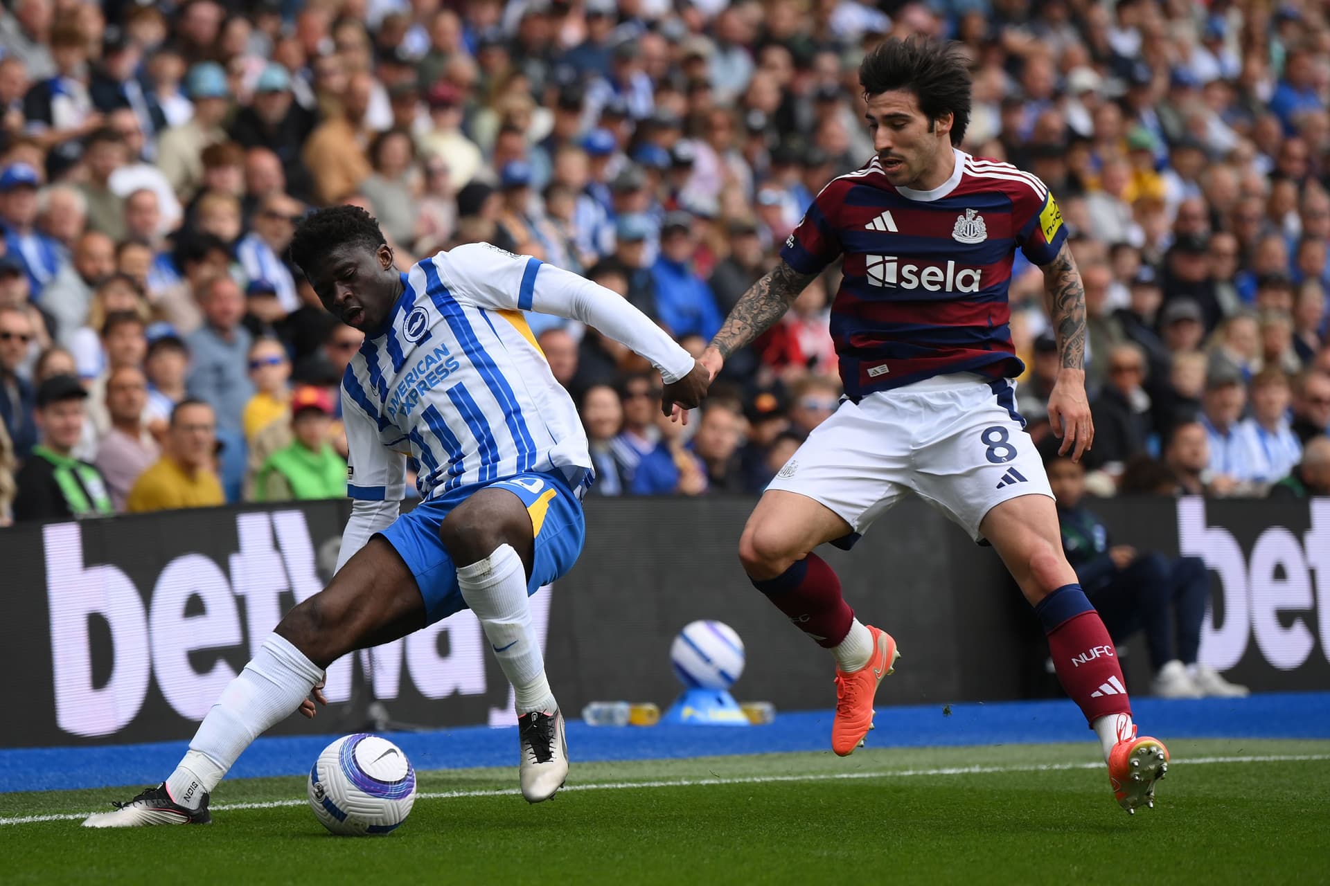 Carlos Baleba of Brighton & Hove Albion is challenged by Sandro Tonali of Newcastle United