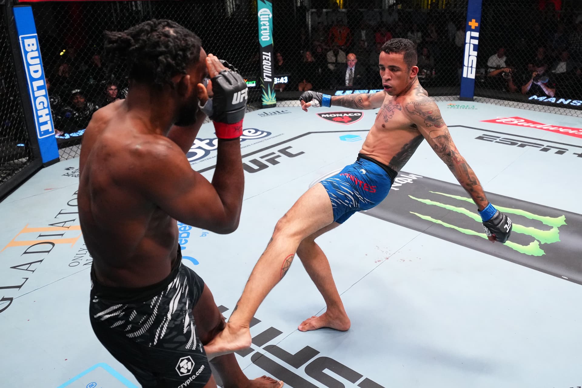 Carlos Prates of Brazil kicks Neil Magny.jpg