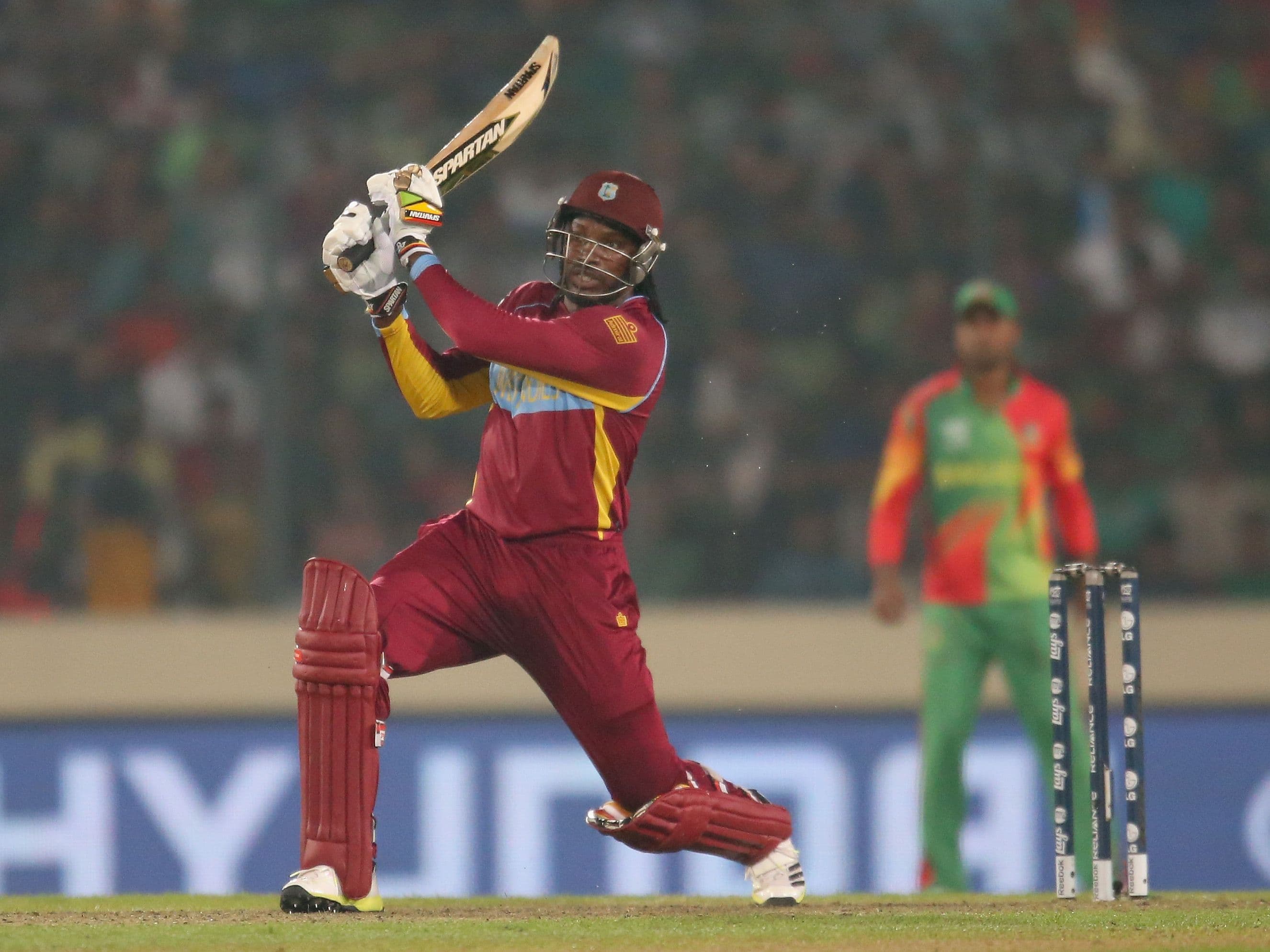 Chris Gayle of the West Indies hits the ball in the air