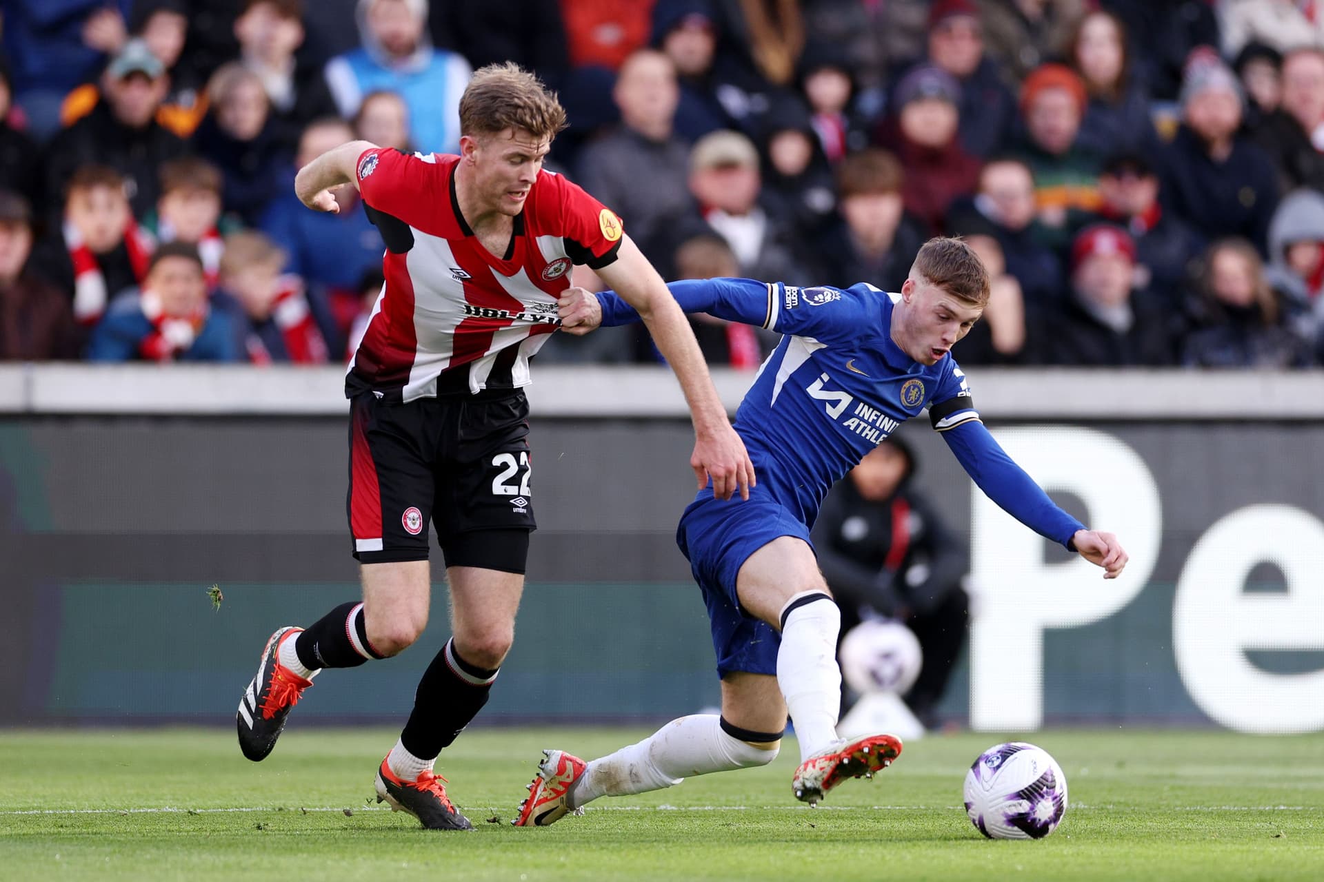 Cole Palmer of Chelsea is challenged by Nathan Collins of Brentford
