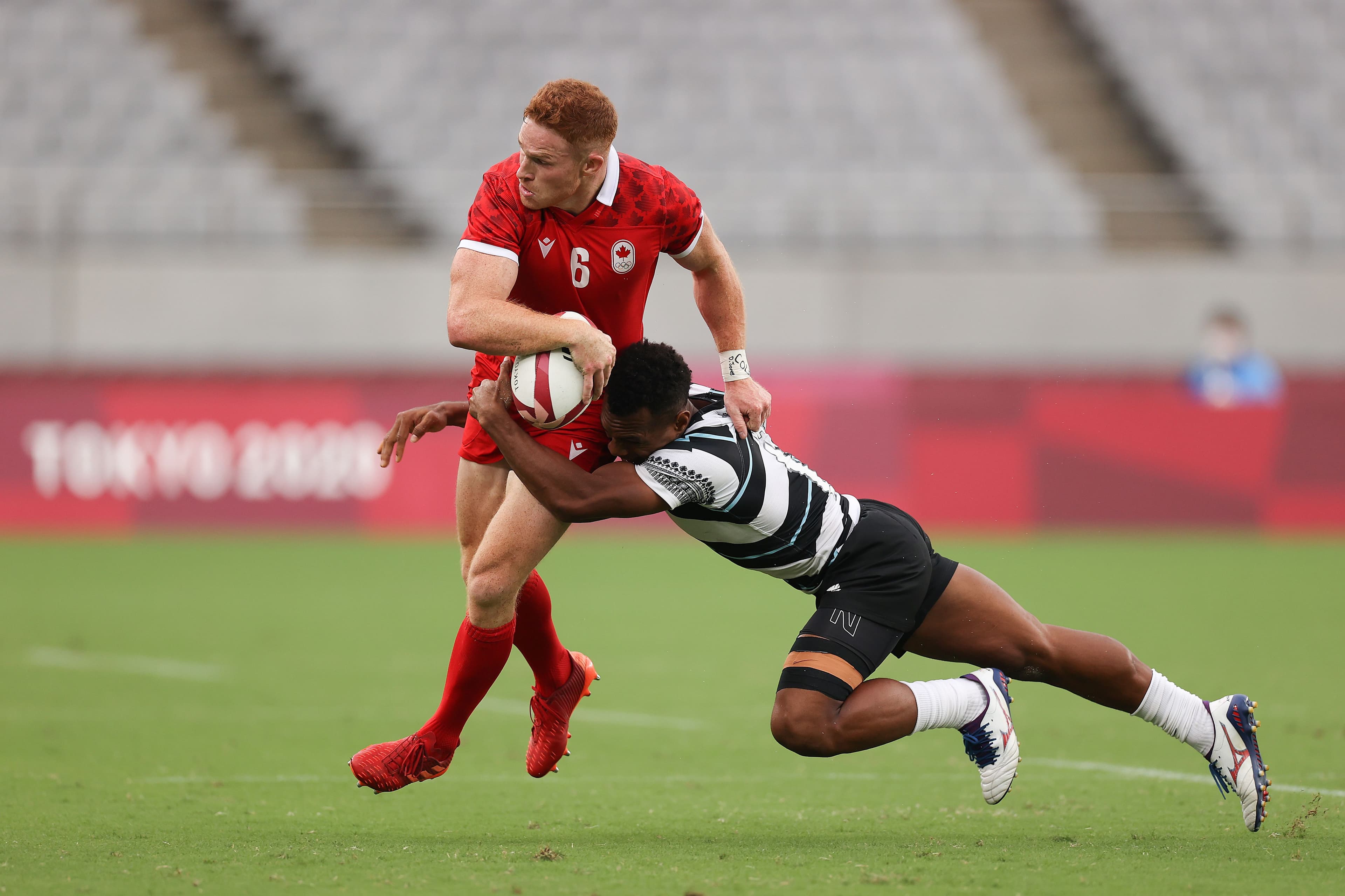 Connor Braid of Team Canada is tackled by Sireli Maqala of Team Fiji