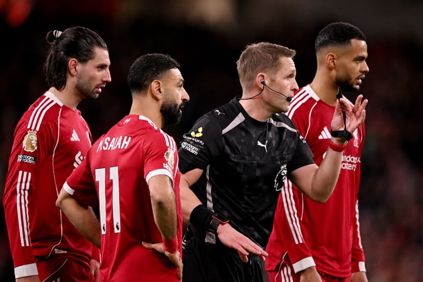 Craig Pawson speaks to players during the Premier League