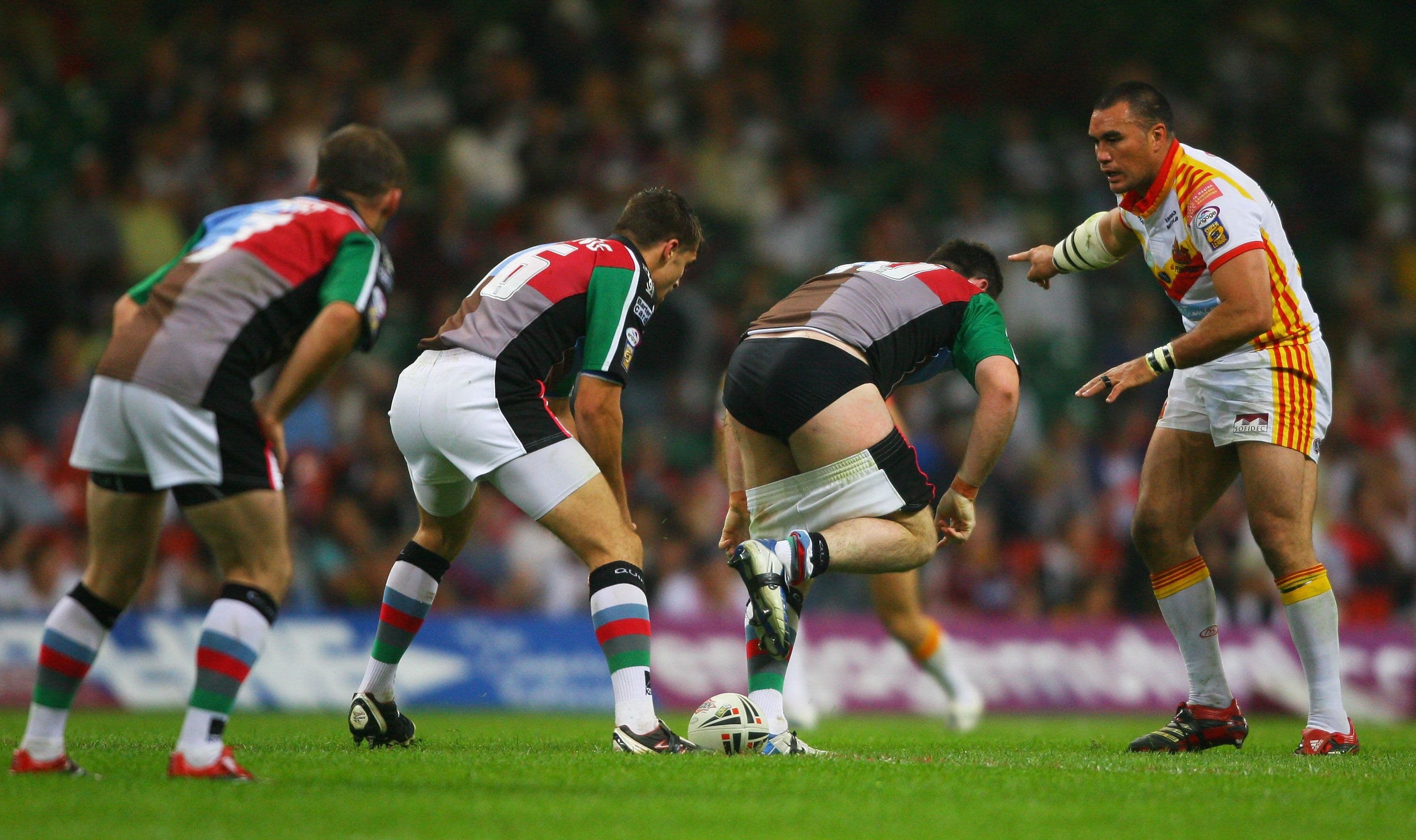 Daniel Heckenberg of Harlequins plays the ball with his shorts round his knees