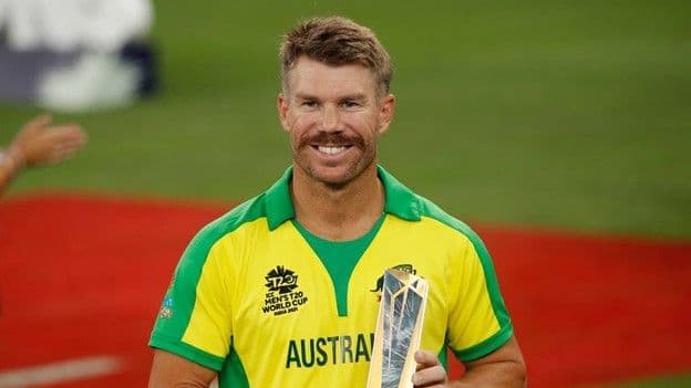 David Warner in an Australia national cricket kit holding an award