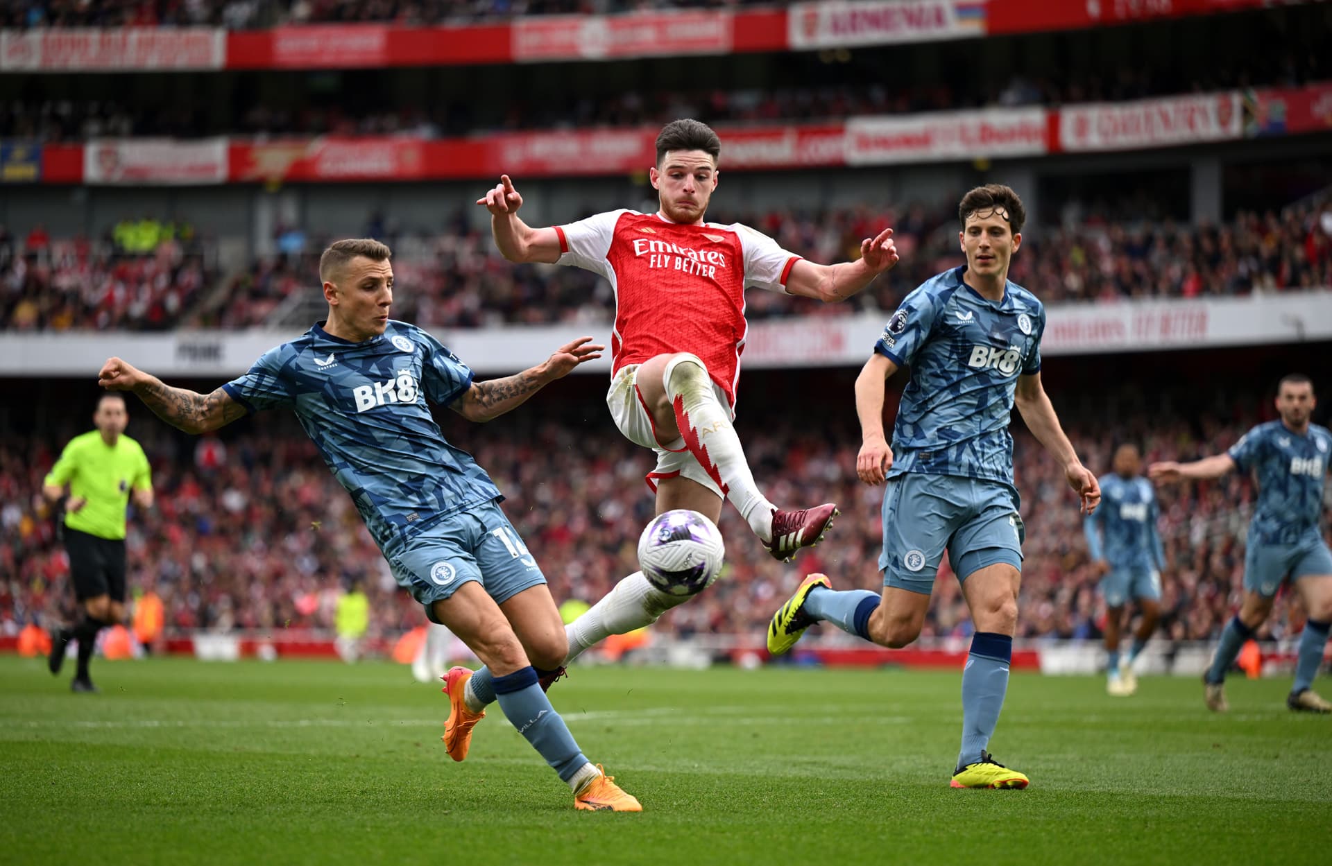 Declan Rice of Arsenal is challenged by Lucas Digne (L) and Pau Torres of Aston Villa