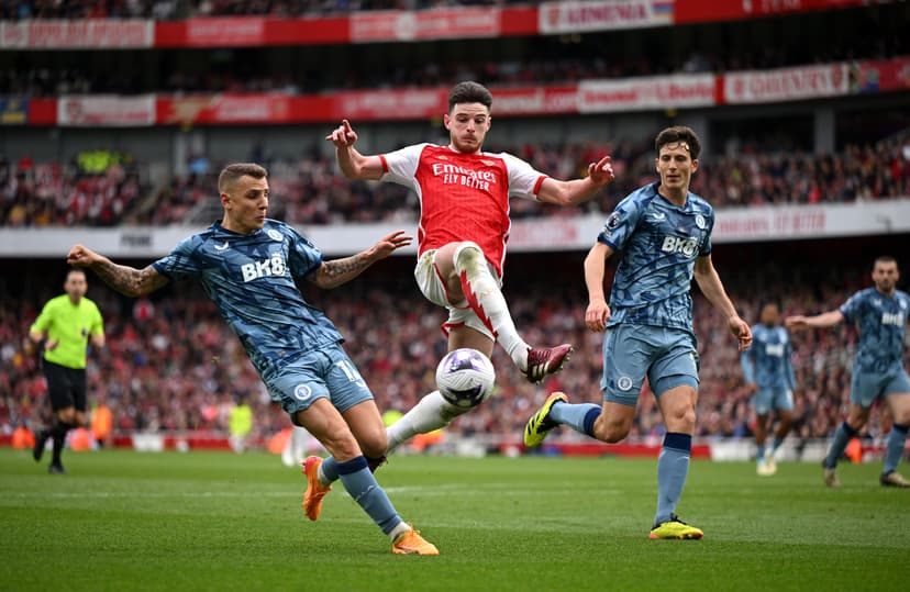Declan Rice of Arsenal is challenged by Lucas Digne (L) and Pau Torres of Aston Villa