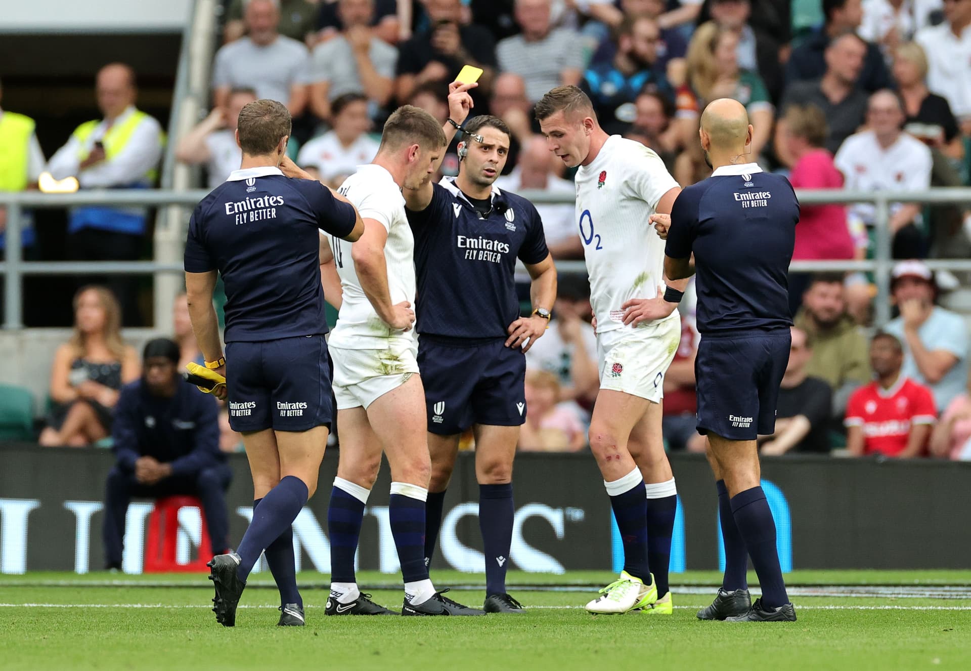 Referee Nika Amashukeli awards a yellow card to Freddie Steward of England