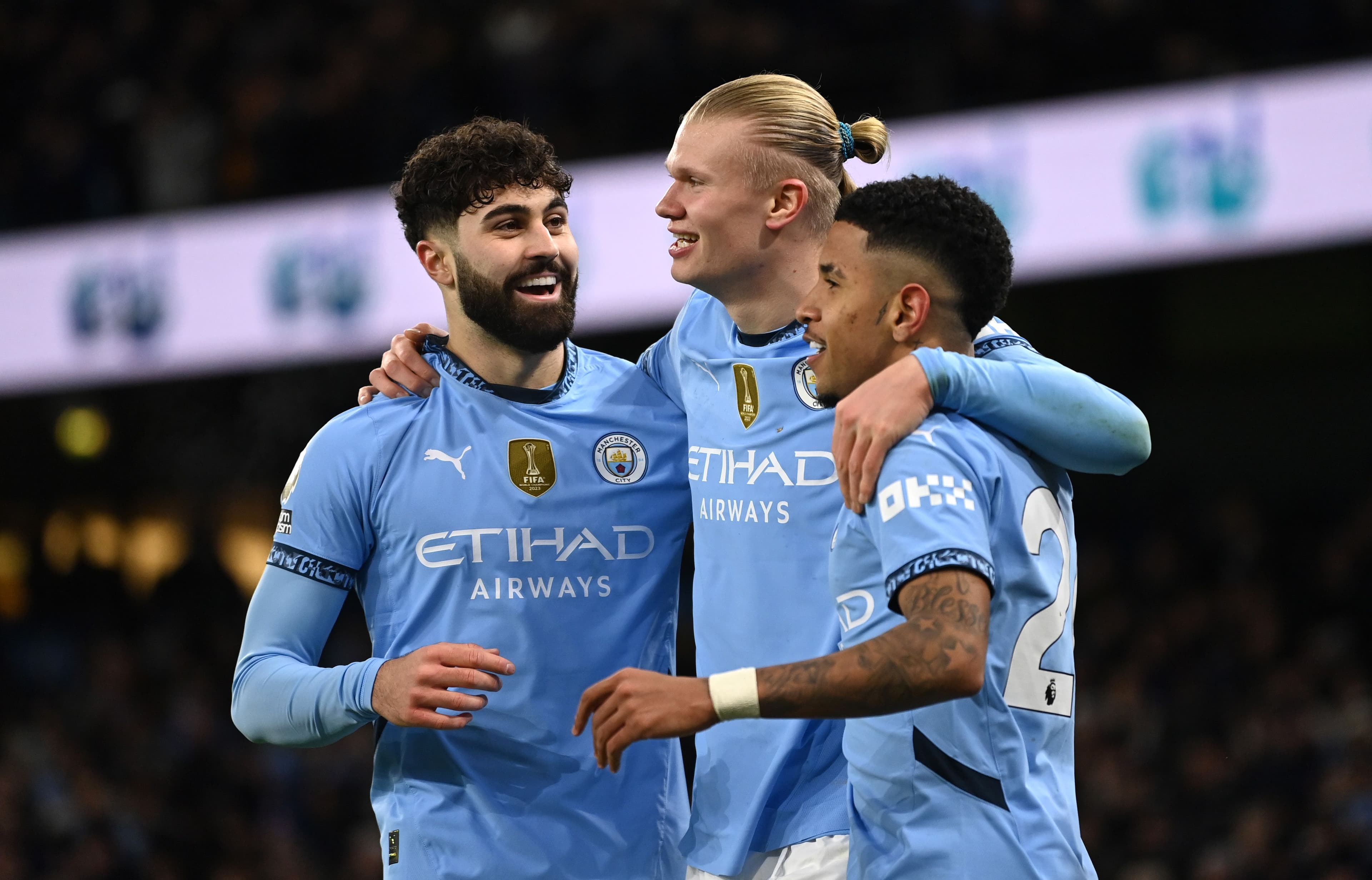 Erling Haaland celebrates scoring his team's third goal with teammates Josko Gvardiol and Savinho