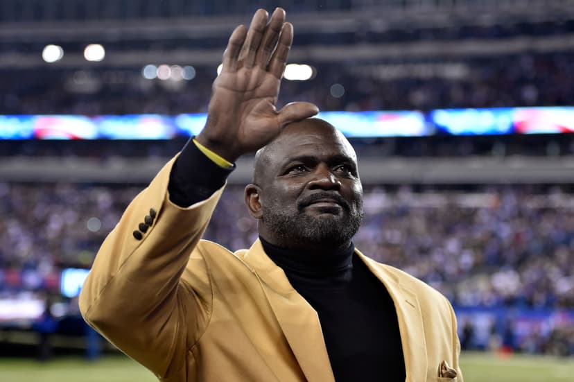 Former New York Giants player Lawrence Taylor waves to the crowd