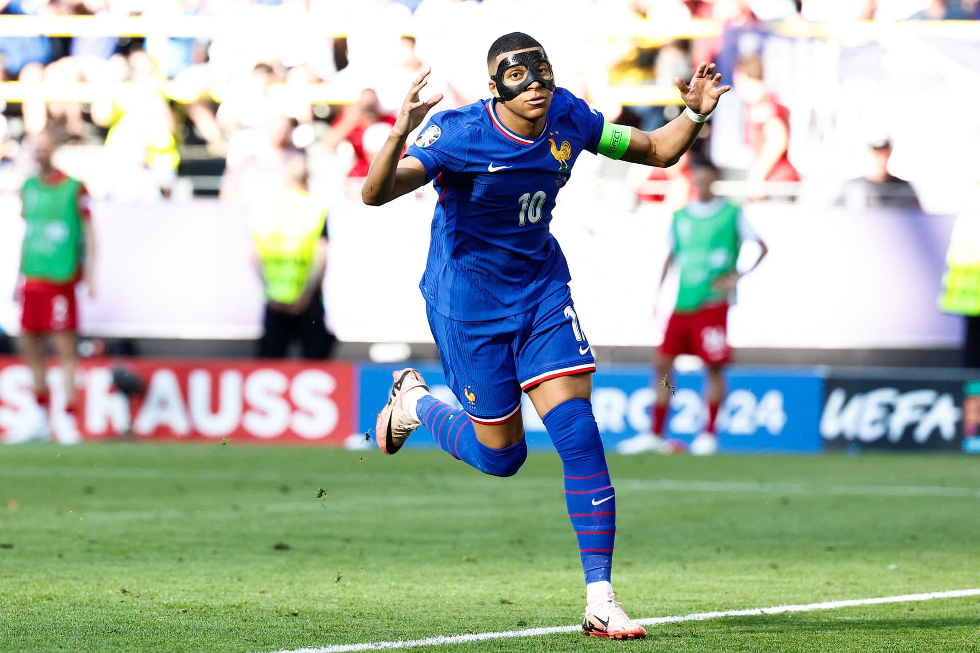 France's forward #10 Kylian Mbappe, wearing a protective mask, celebrates scoring his team's first goal