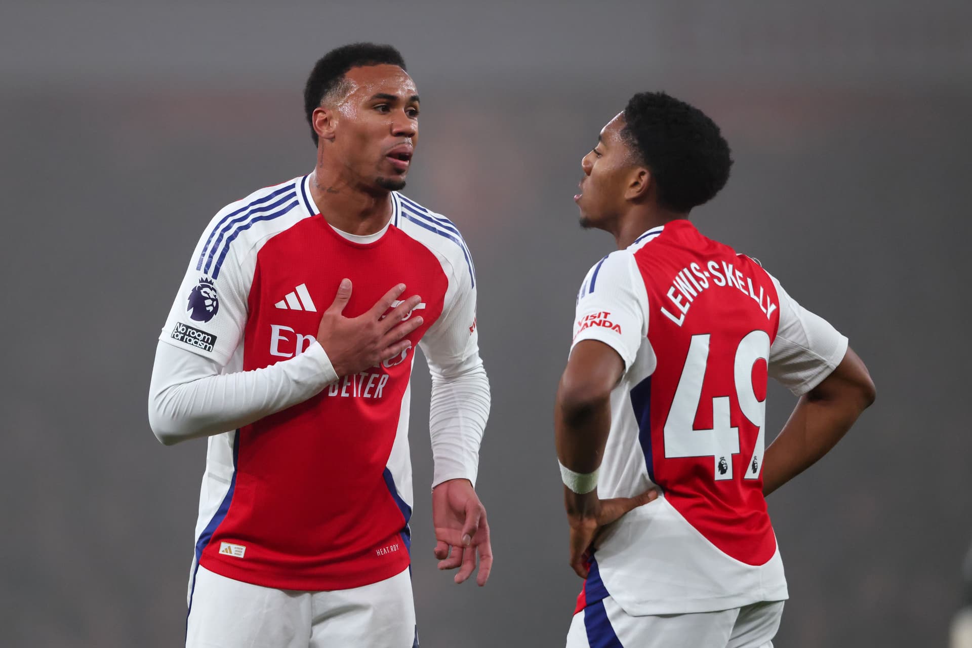 Gabriel Magalhaes of Arsenal speaks with Myles Lewis-Skelly