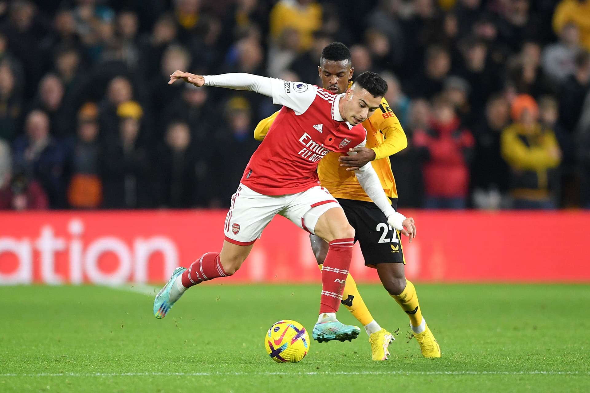 Gabriel Martinelli of Arsenal is challenged by Nelson Semedo of Wolverhampton Wanderers