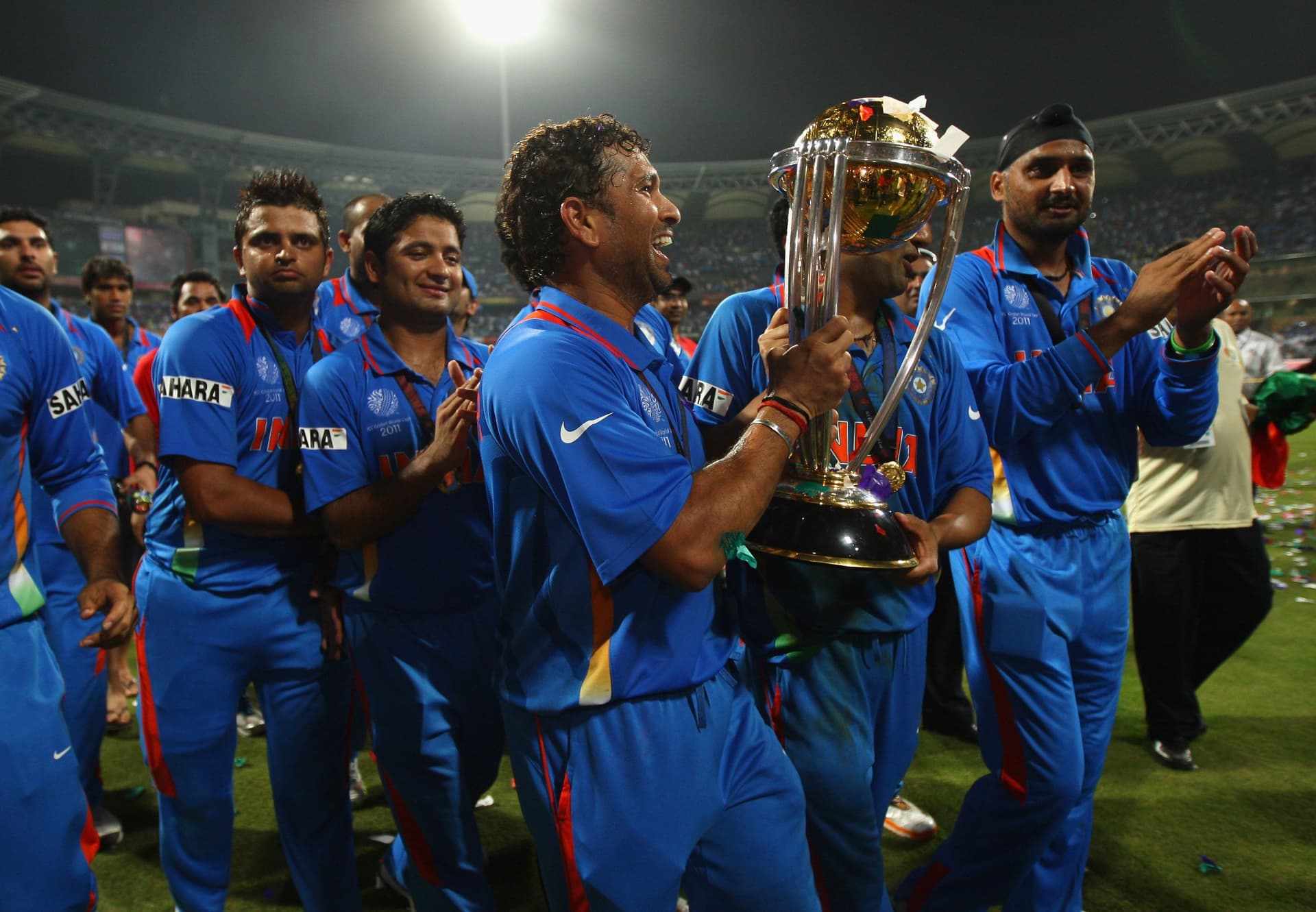 Sachin Tendulkar of India celebrates with the World Cup after beating Sri Lanka during the 2011
