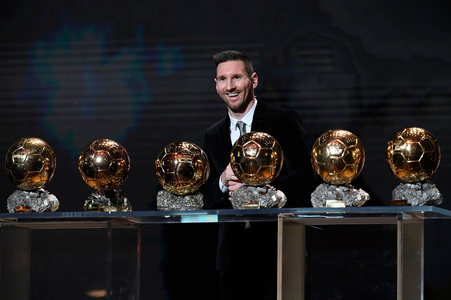 Lionel Messi (ARG / FC Barcelona) poses onstage after winning his sixth Ballon D'Or award