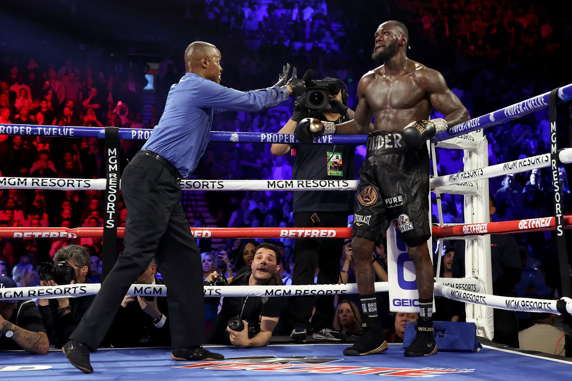 Referee Kenny Bayless sends Deontay Wilder to his corner during the Heavyweight