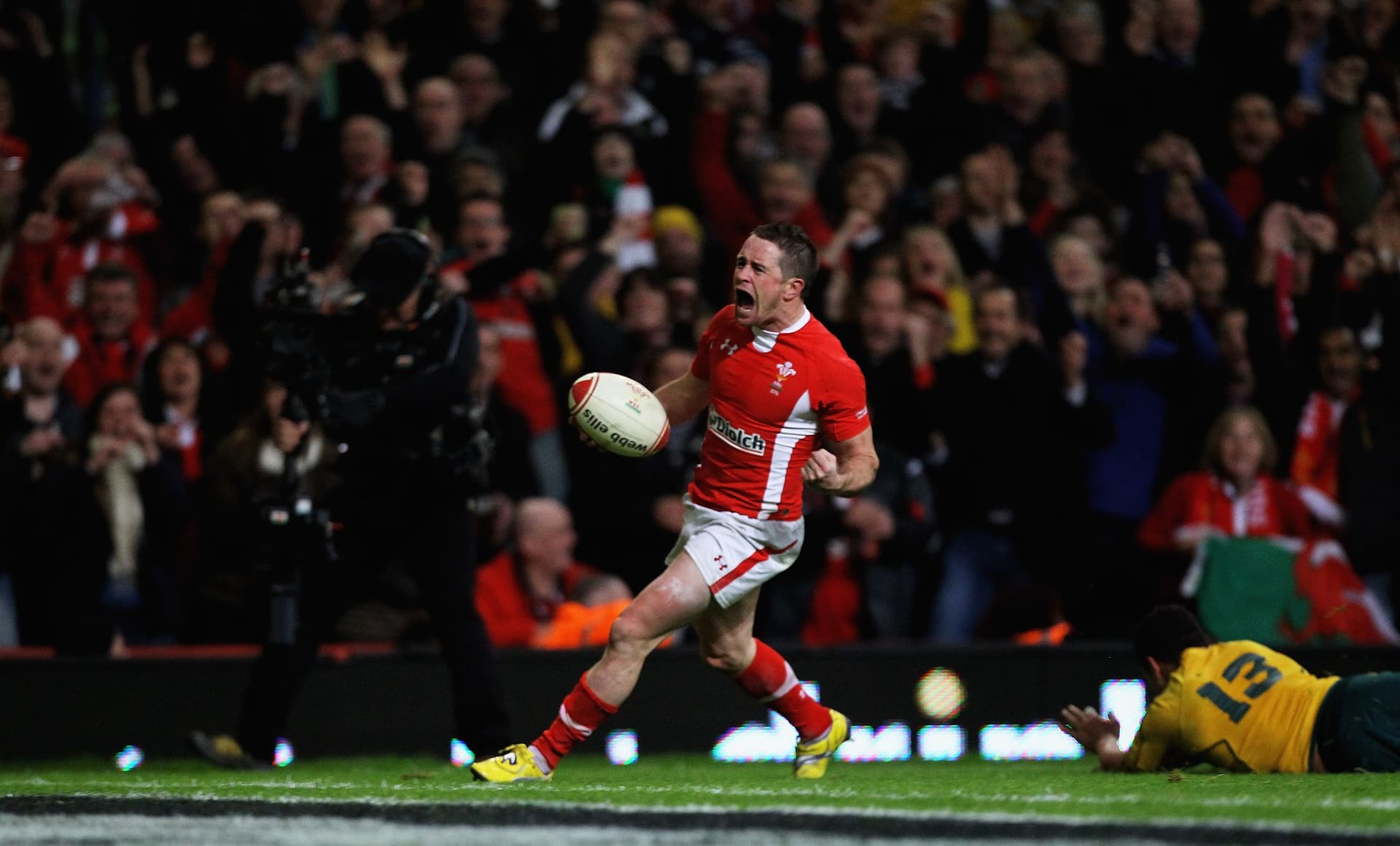 Shane Williams of Wales celebrates scoring a try d