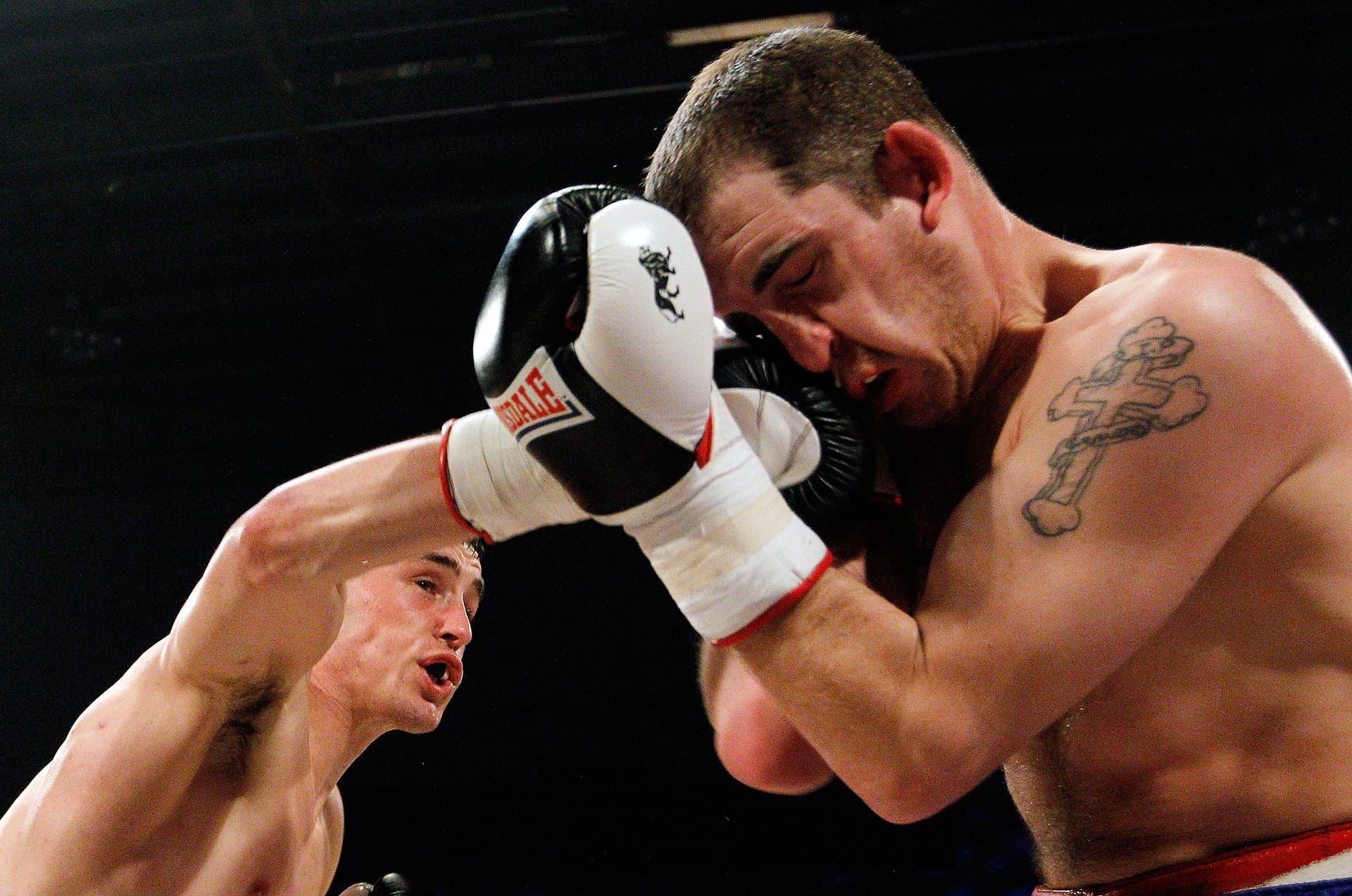 Justin Newell in action with Johnny Greaves during their Light Welterweight