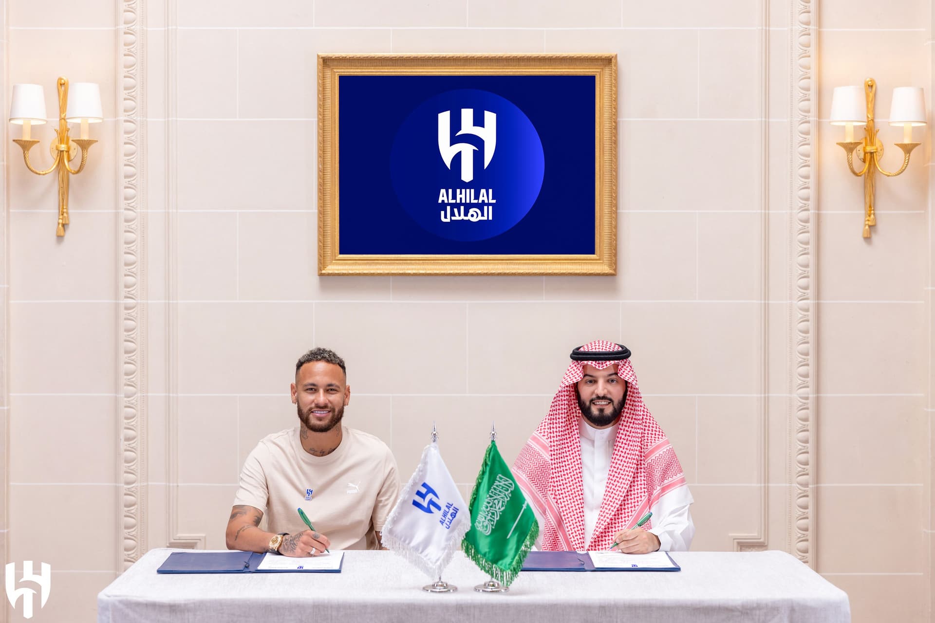 Brazilian football star Neymar (L) and Al-Hilal's president Fahad bin Nafel (R)
