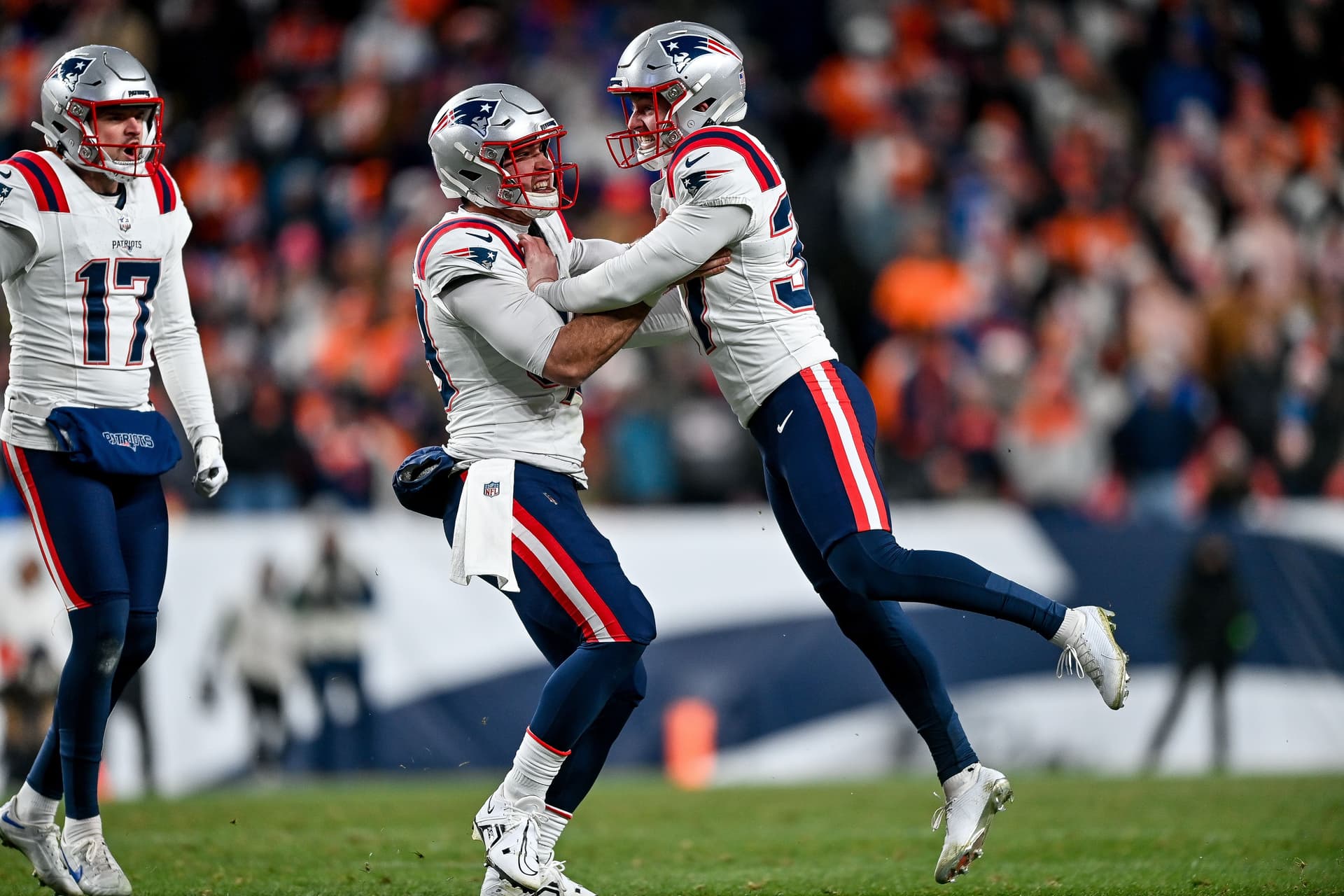 Chad Ryland #37, Joe Cardona #49, and Bryce Baringer #17 of the New England Patriots celebrate