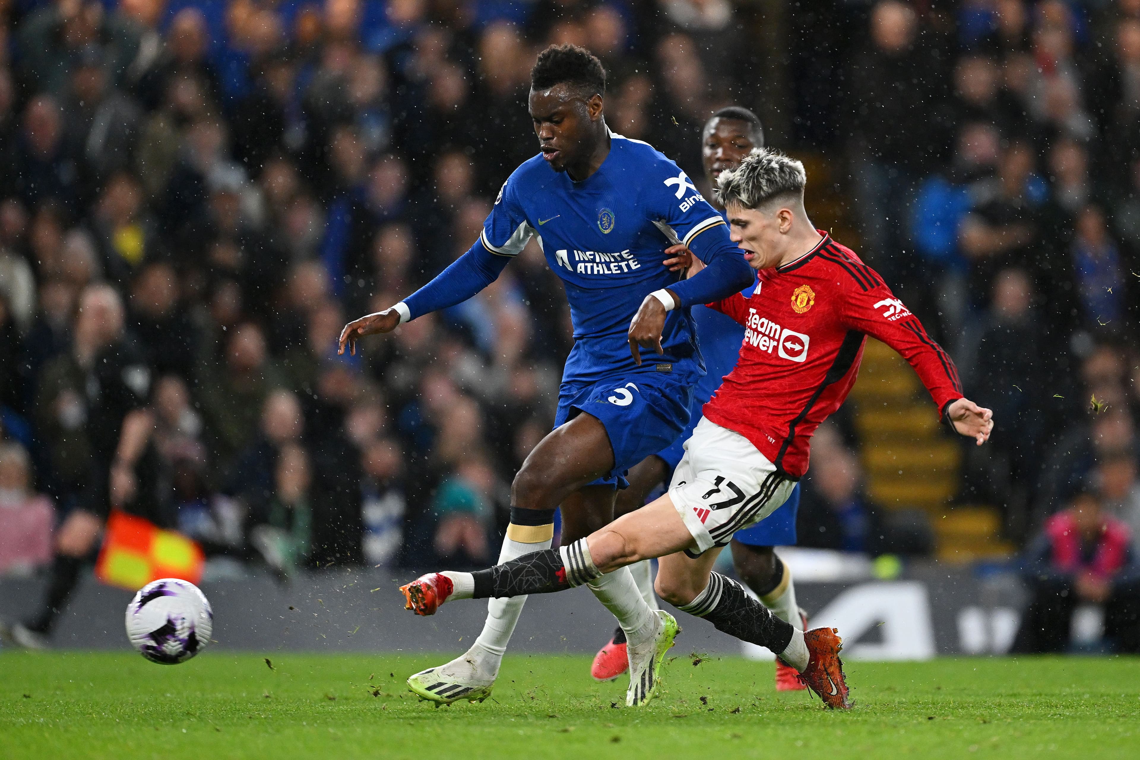 Alejandro Garnacho of Manchester United scores his team's first goal whilst under pressure from Benoit Badiashile