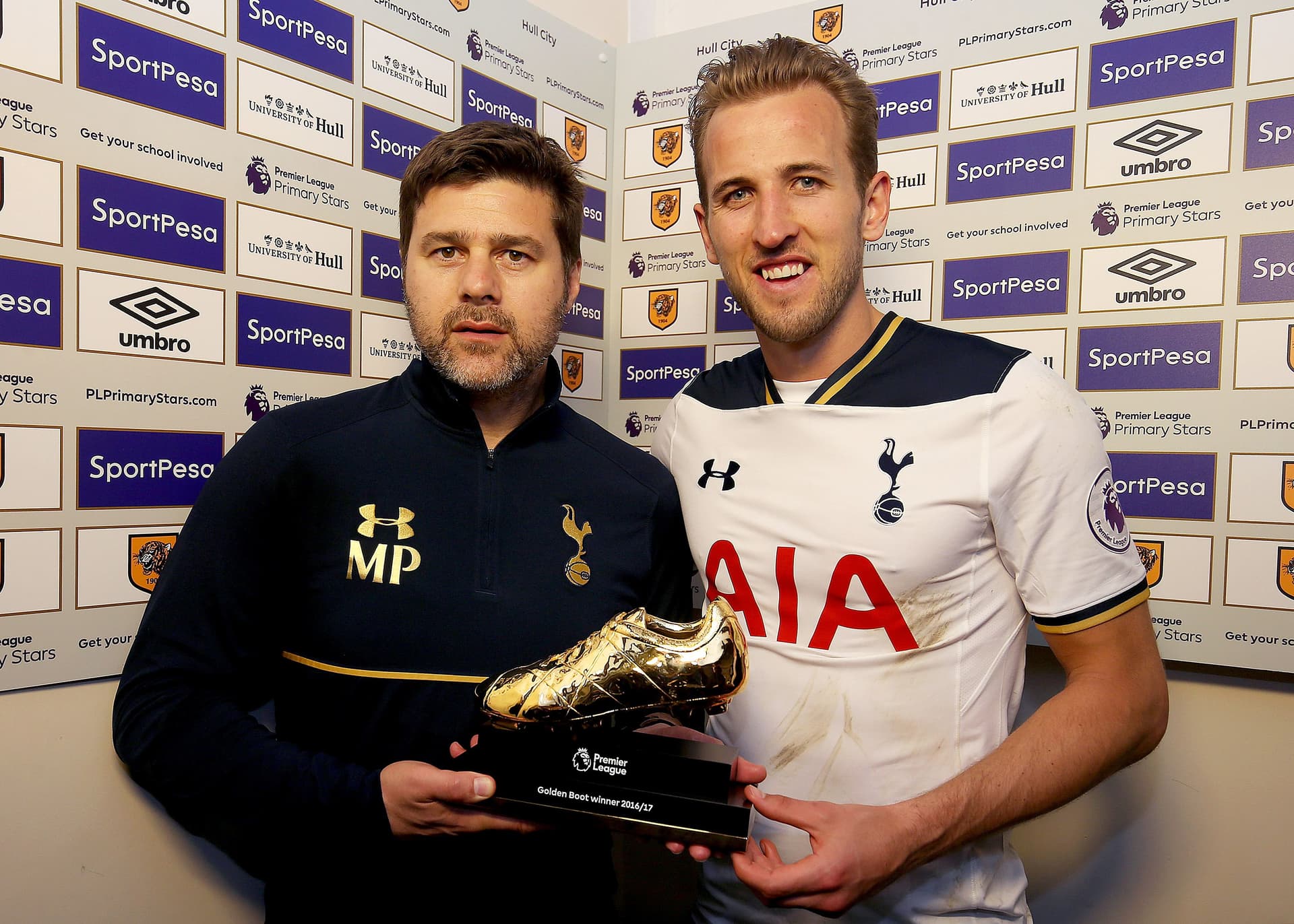 Harry Kane of Tottenham Hotspur stands with his manager Mauricio Pochettino